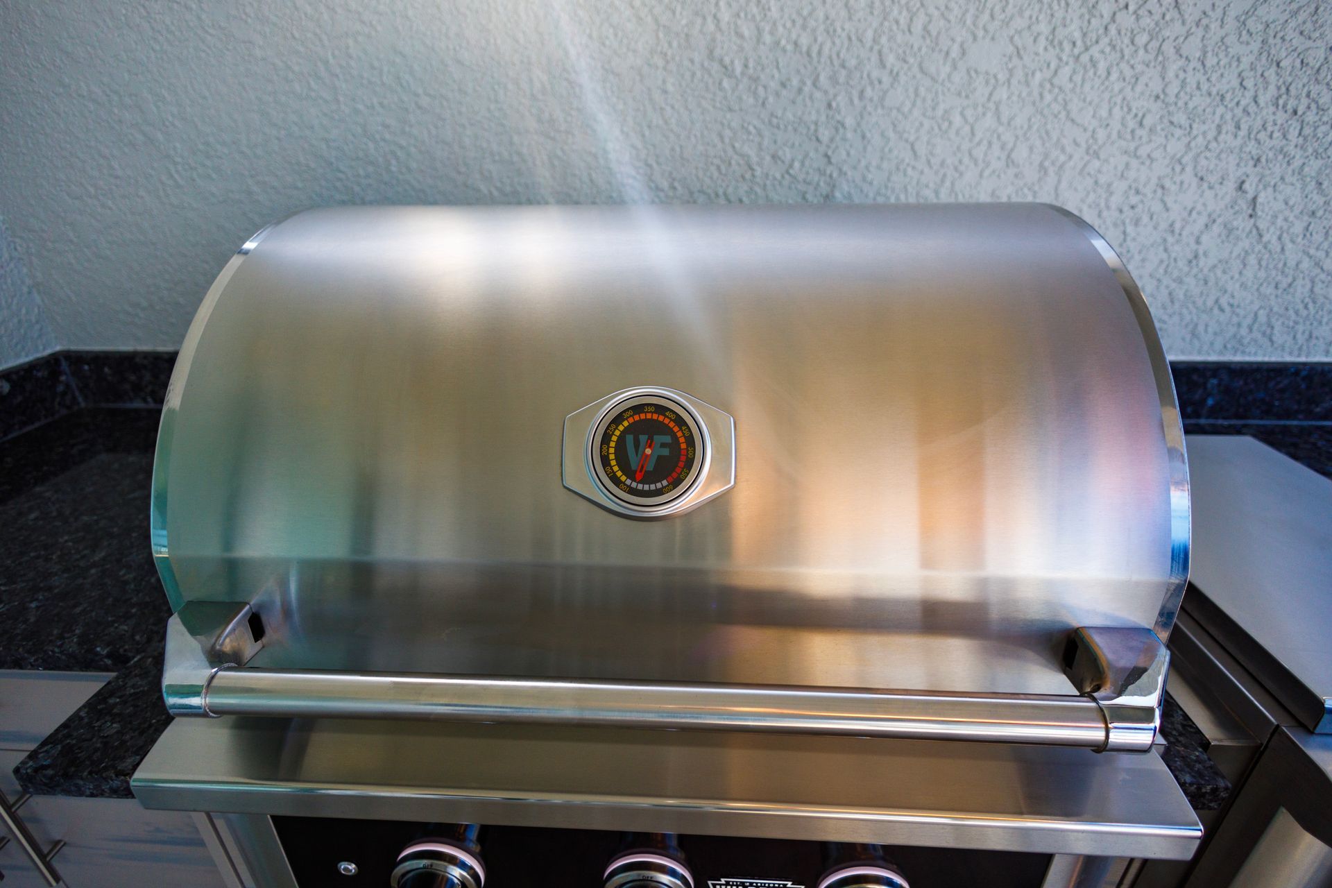 A stainless steel grill is sitting on top of a counter