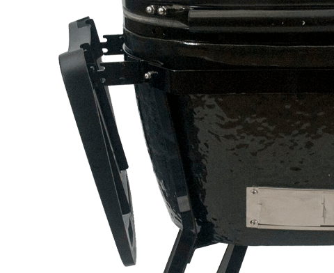 A black grill with a black cutting board attached to it.