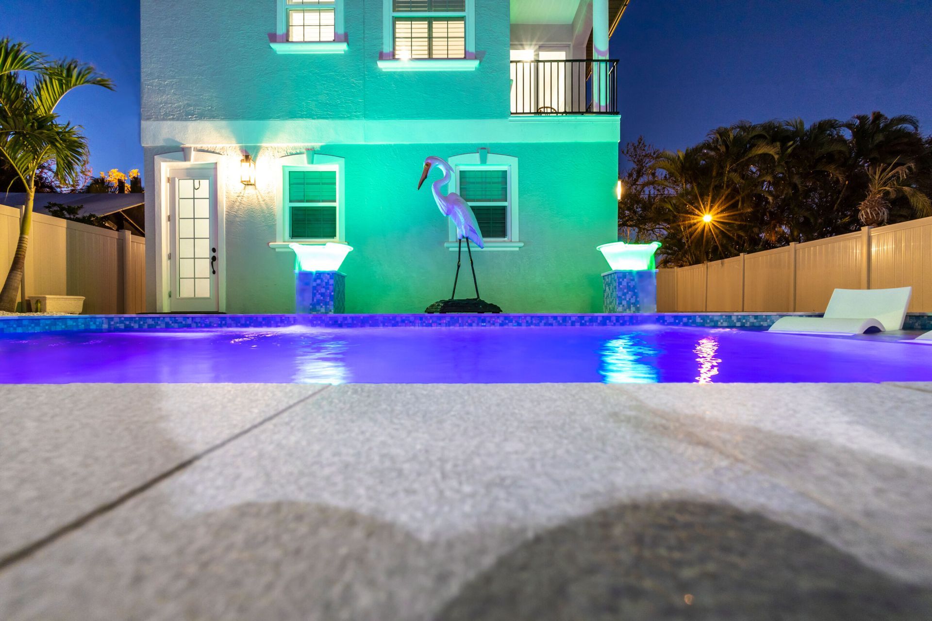 A house with a swimming pool in front of it.
