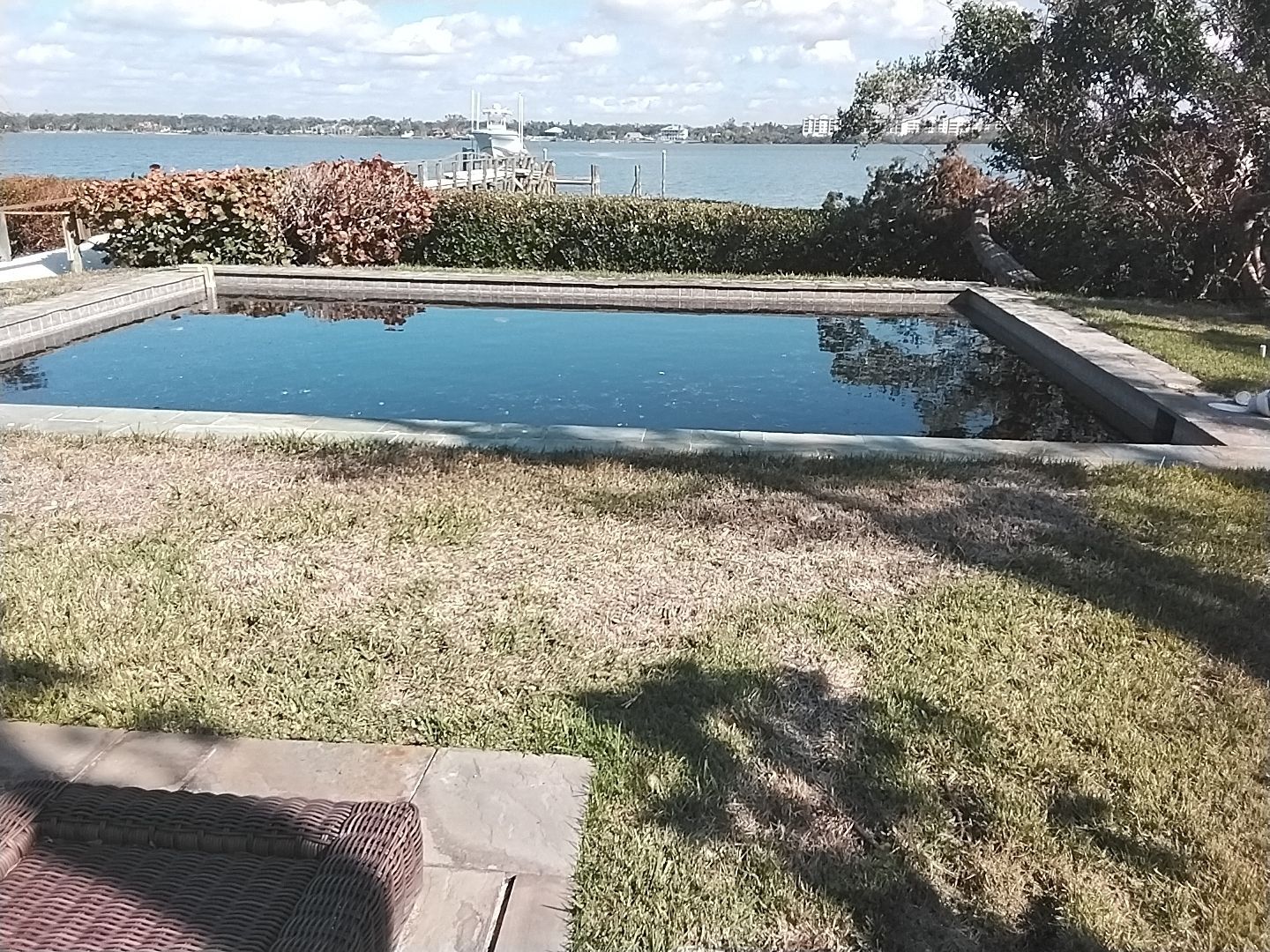 A large swimming pool with a view of the ocean.