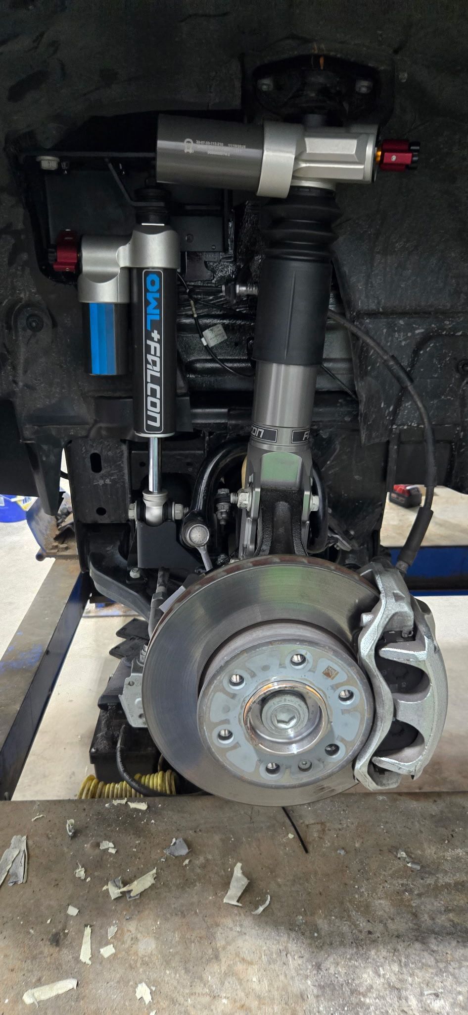 Front suspension system with a shock absorber, brake rotor, and caliper.