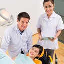 Dentist with patient and nurse