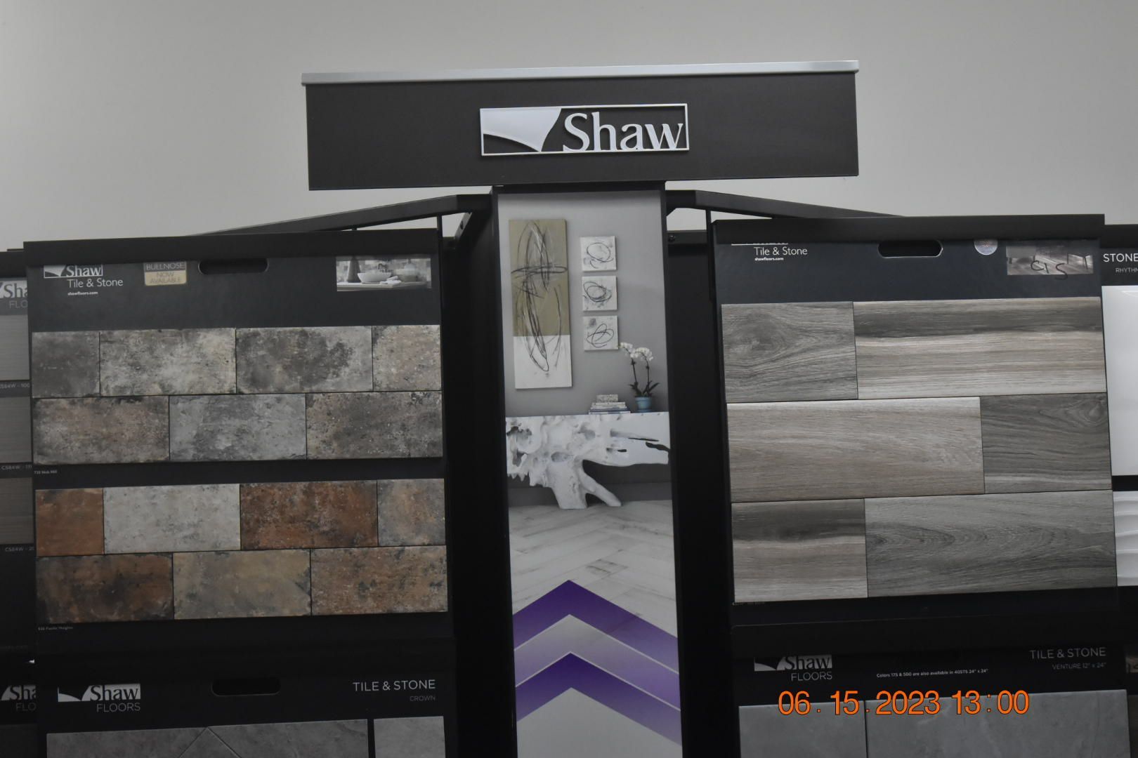 Shaw flooring display with stone and wood sample panels in a showroom