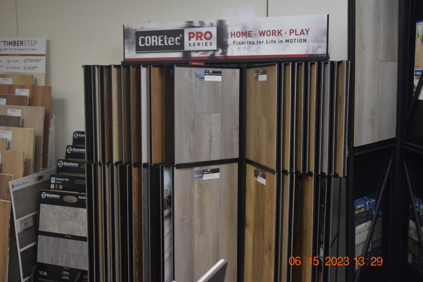 Store display of wood-look flooring samples in a showroom, with COREtec and PRO signs above.