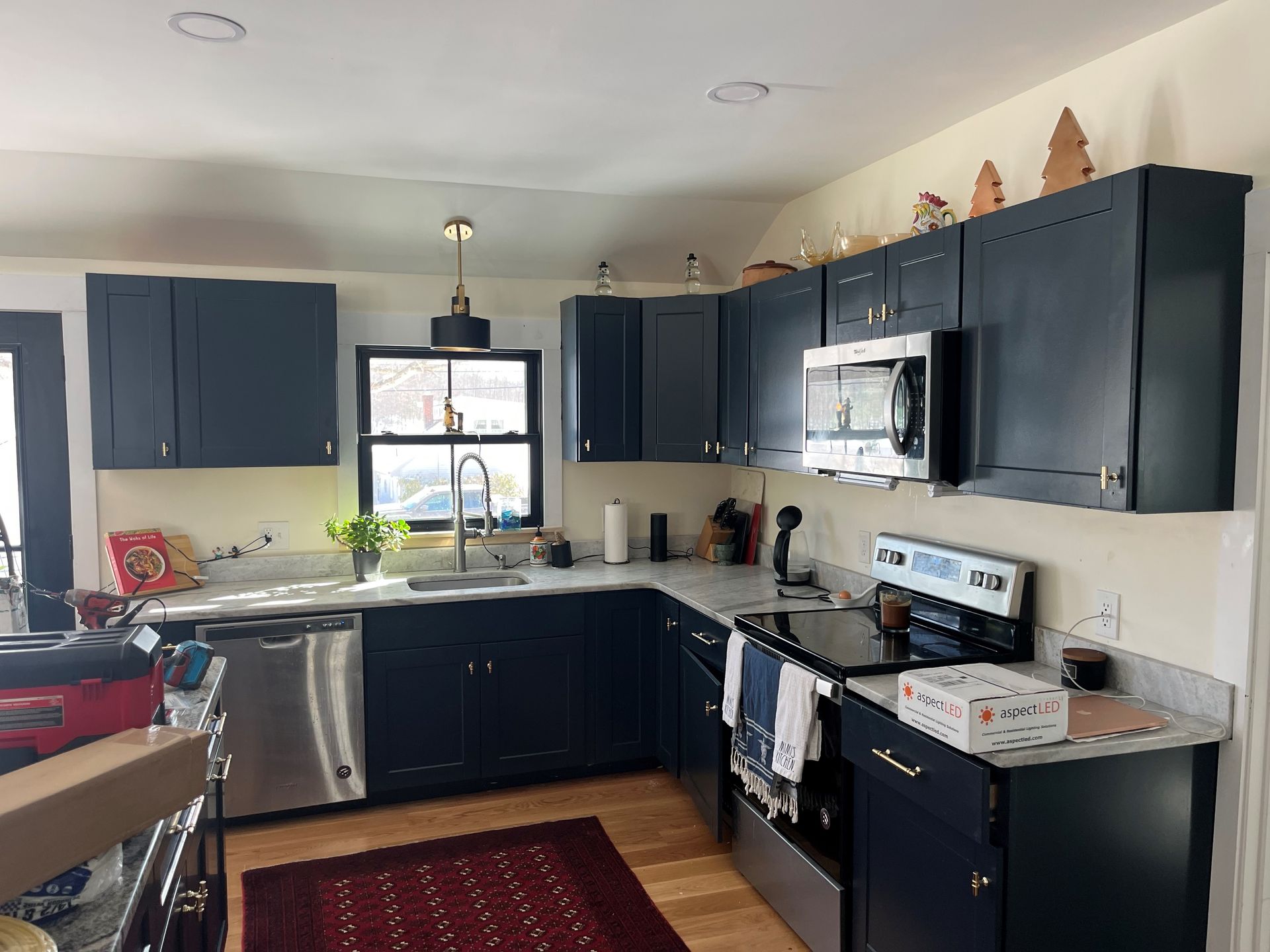 a kitchen with black cabinets and stainless steel appliances