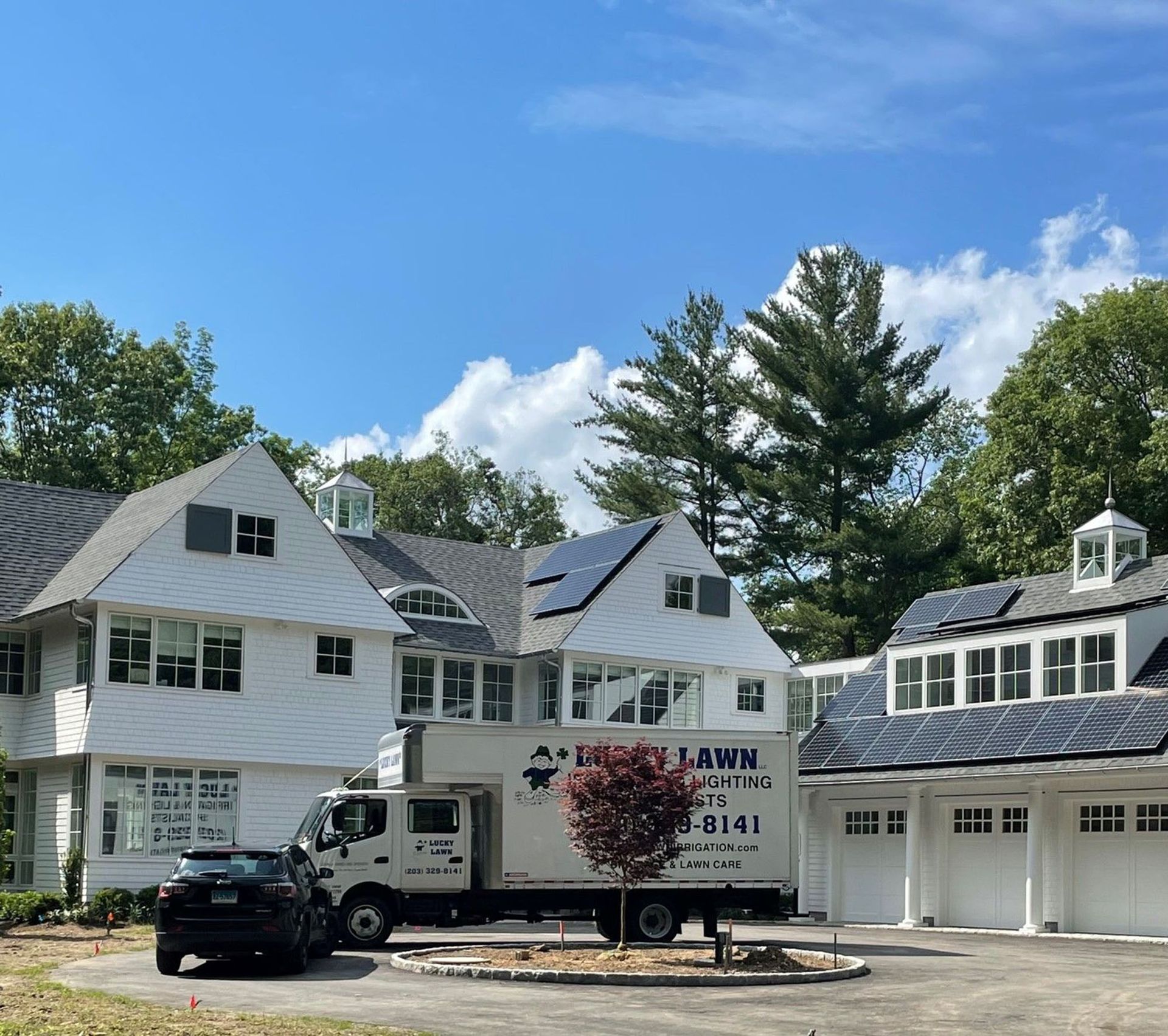 Lucky Lawn's service truck parked outside the house.