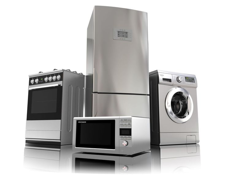 Stainless steel appliances: stove, refrigerator, microwave, and washing machine.