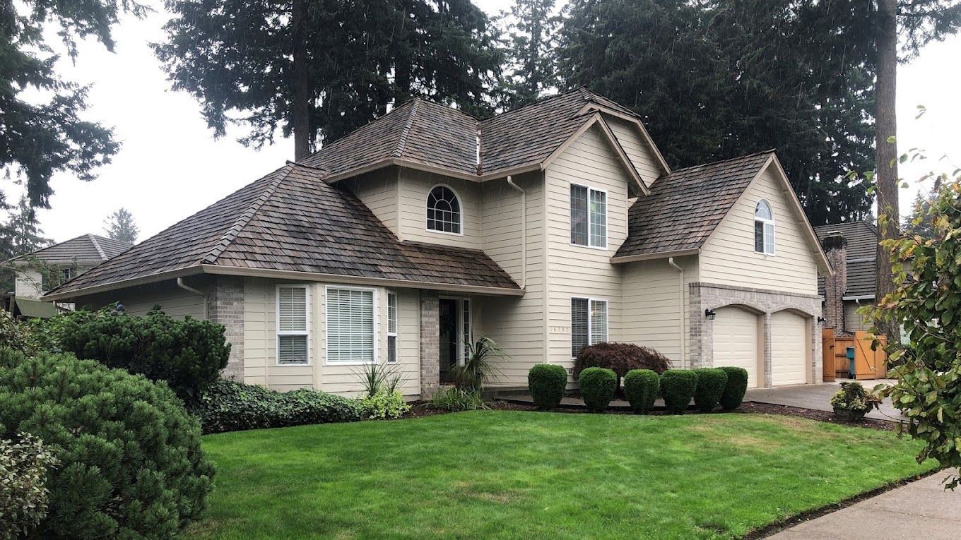 A large house with a lush green lawn in front of it.