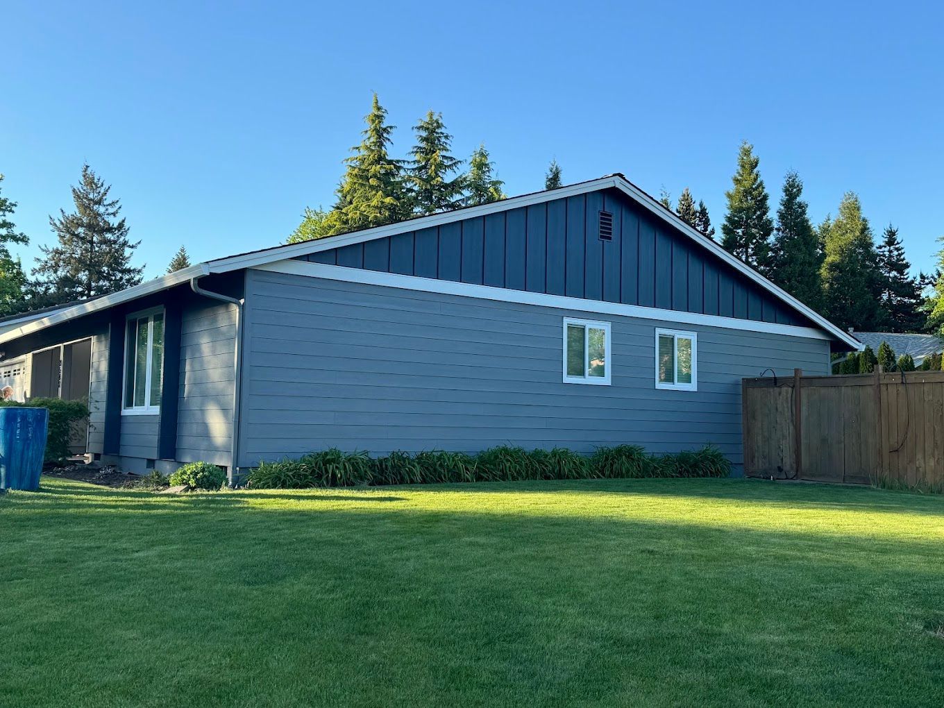 A house with a lot of grass and a sign in front of it.