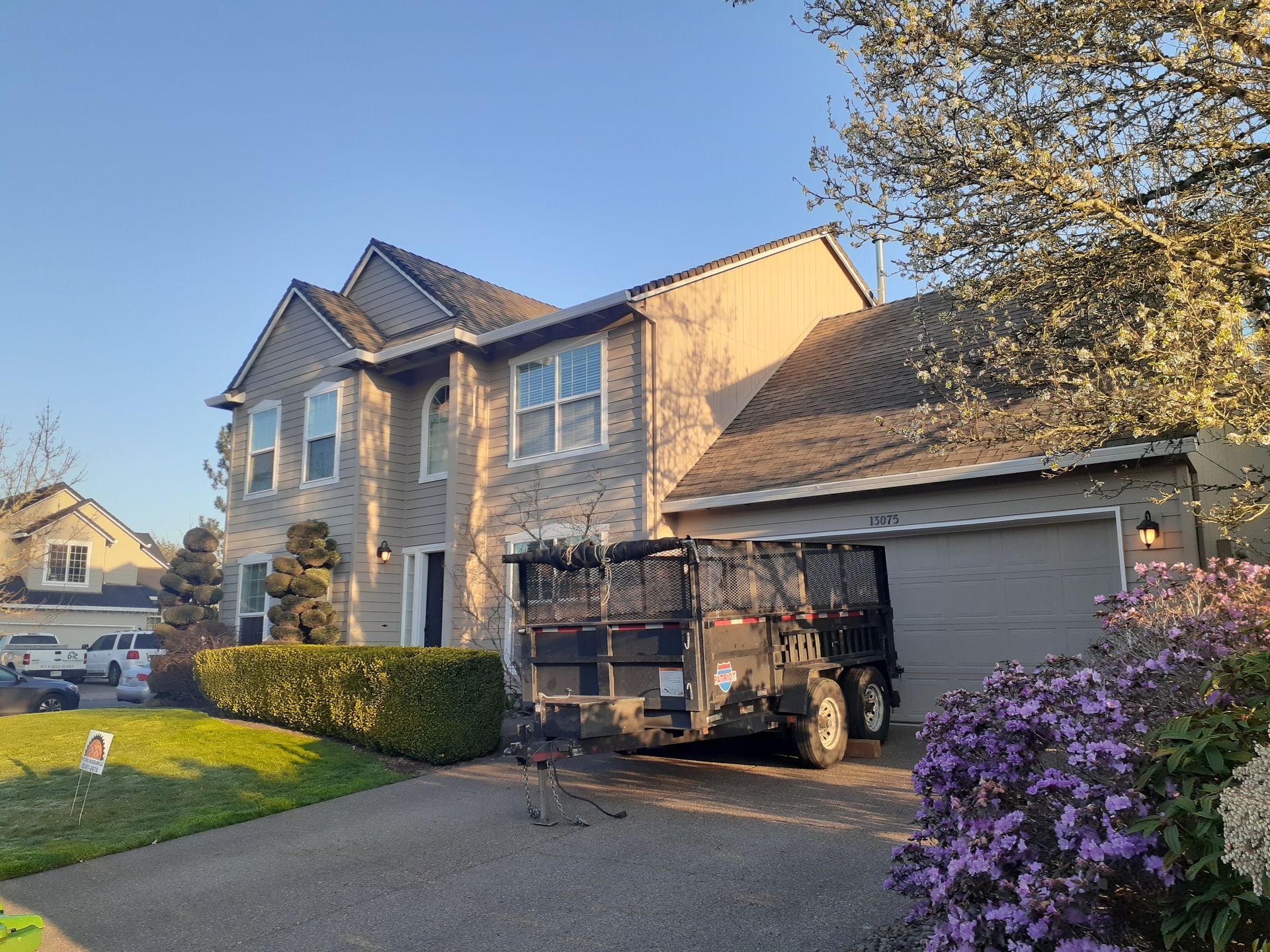 A utility vehicle is parked in front of a large house.