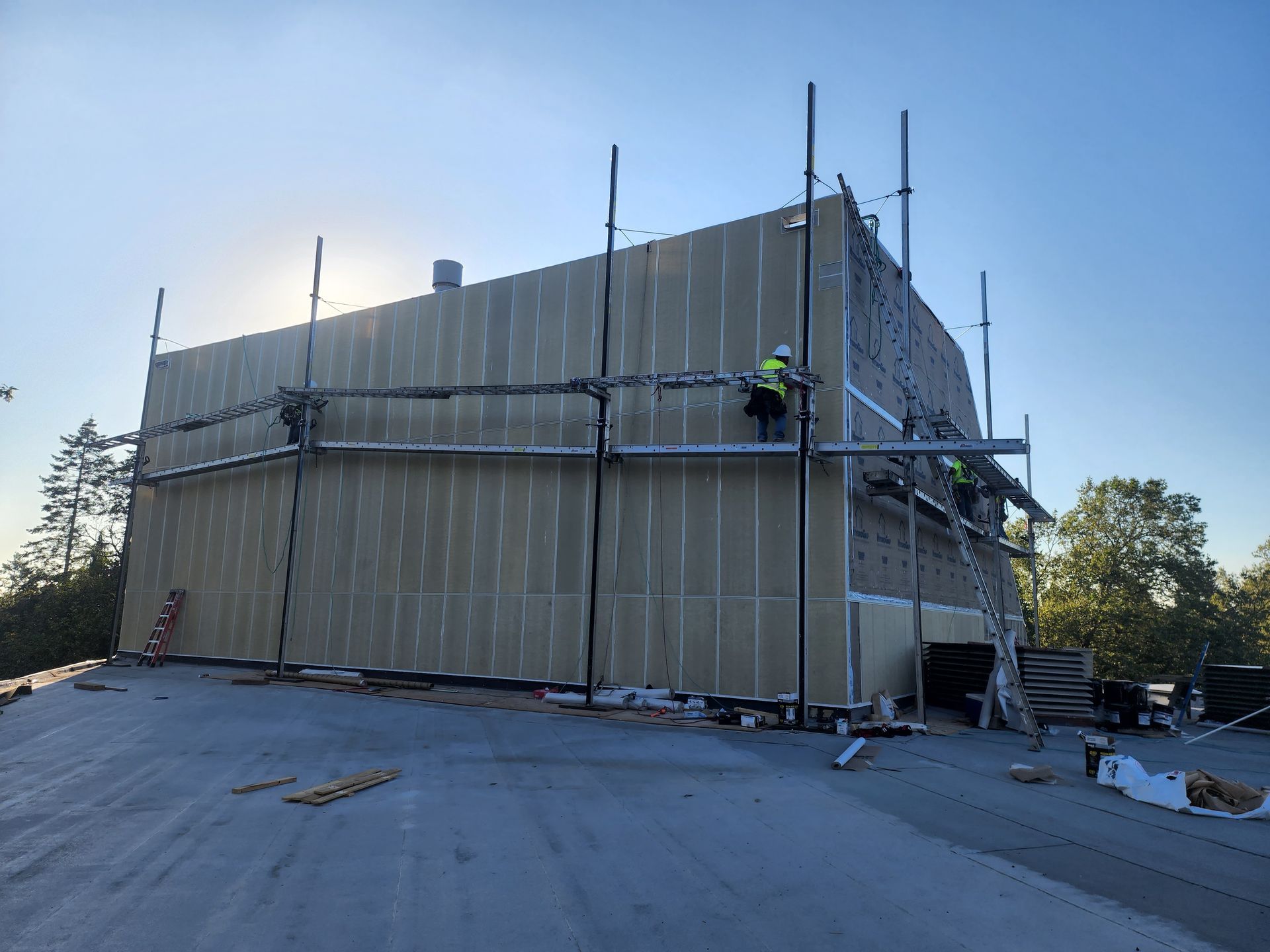 A group of construction workers are working on a large building.