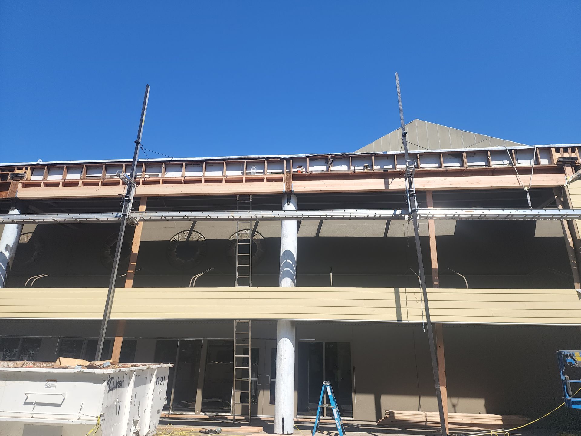 A building under construction with a blue sky in the background