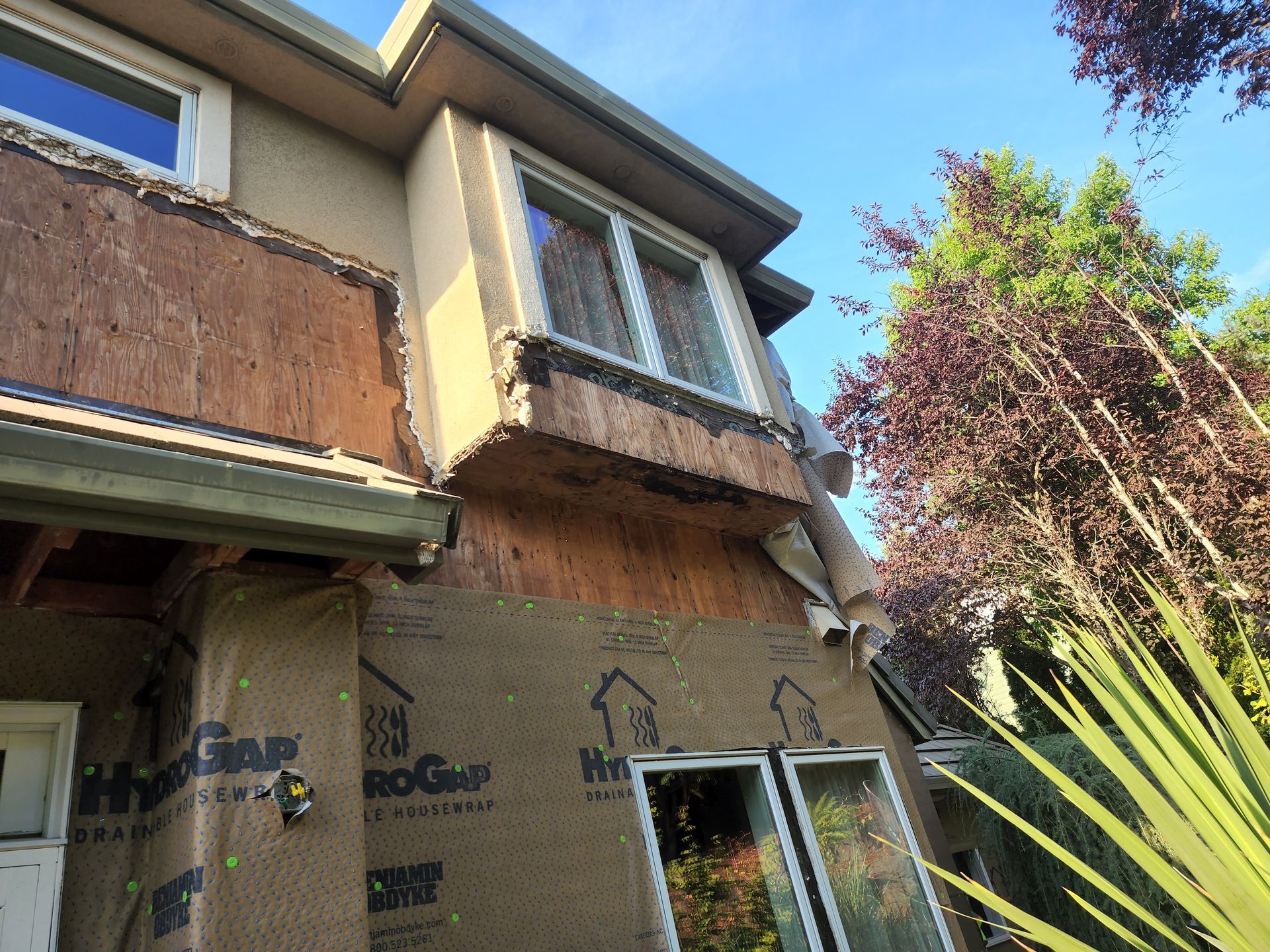 A house with a lot of windows is being remodeled.