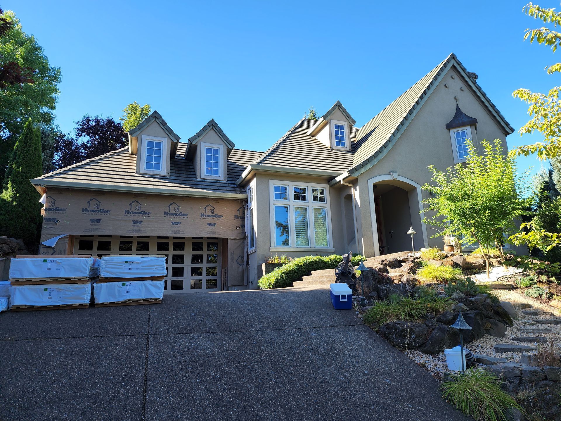 A large house with a blue cooler in front of it