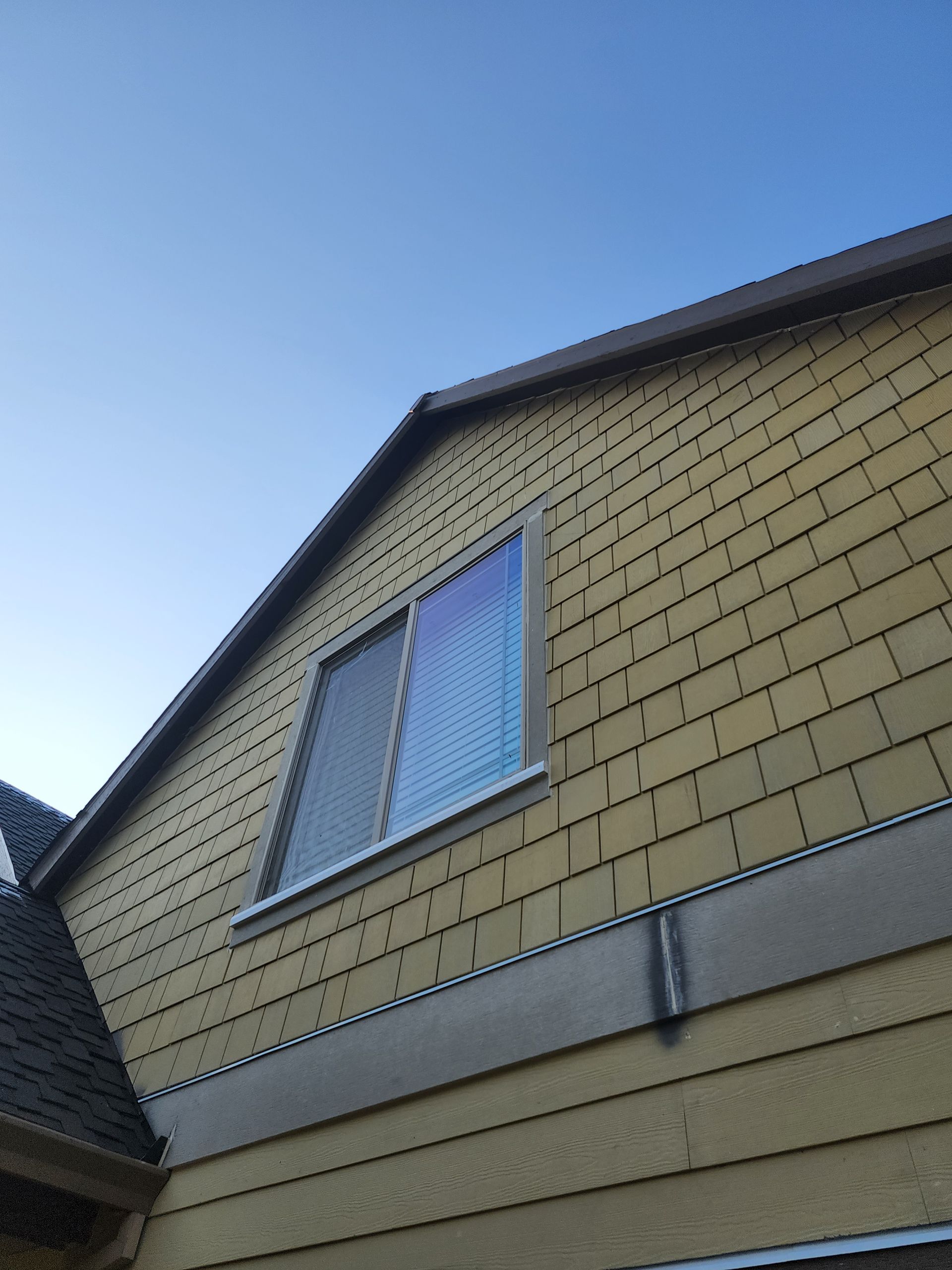 Looking up at a house with a blue sky in the background