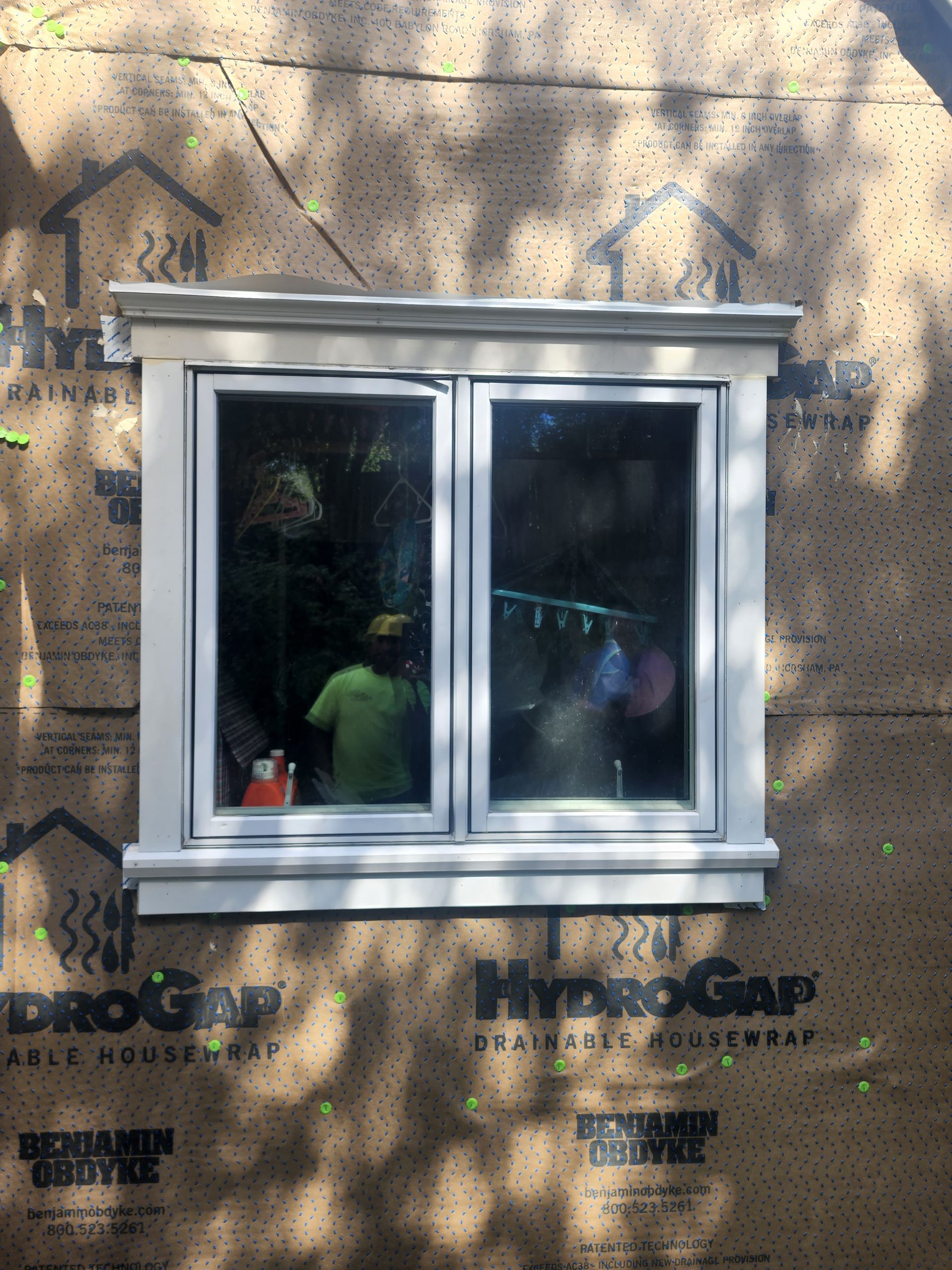 A window on a house that is covered in hydrogap