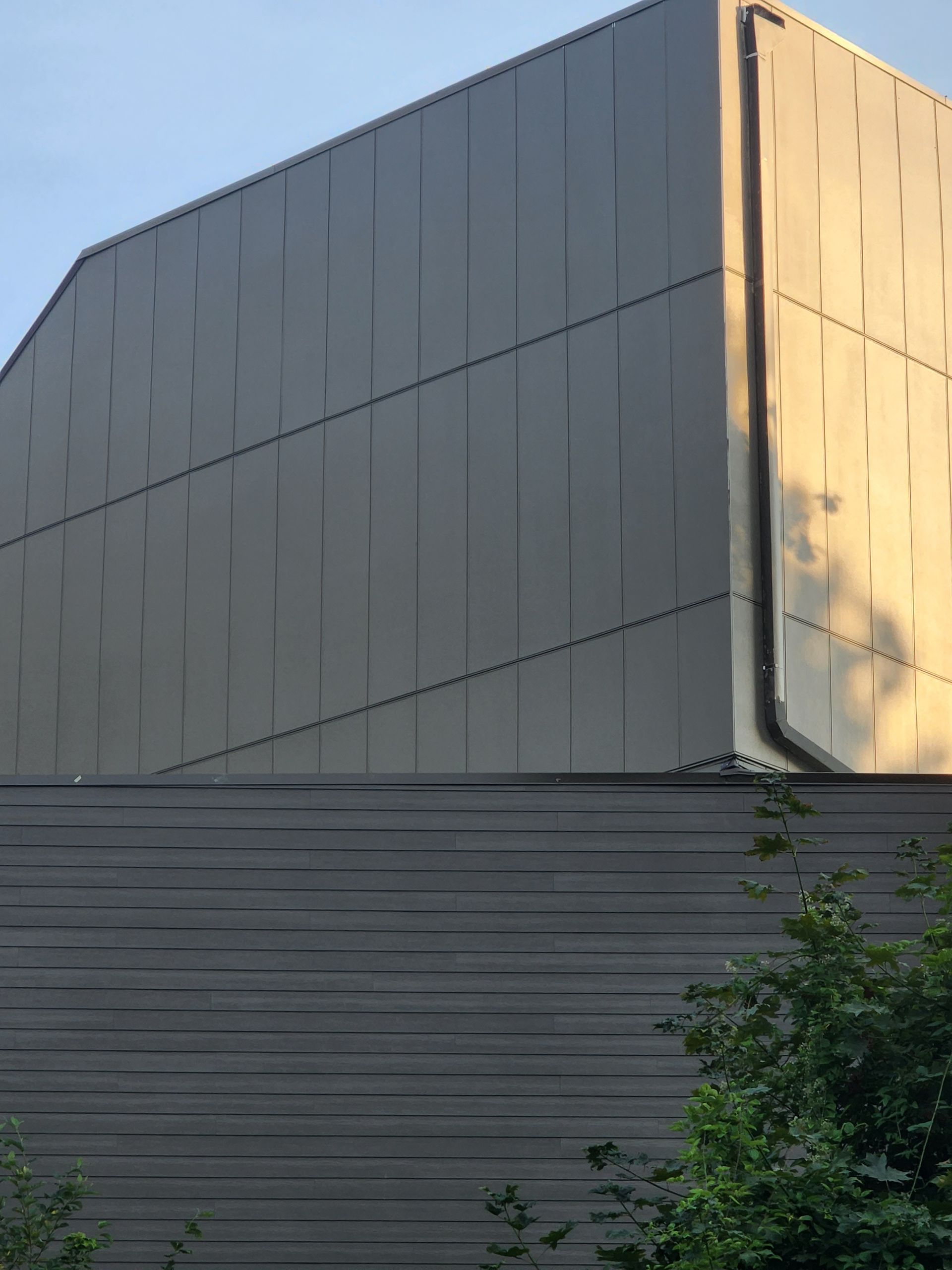 A large building with a roof that has a drainpipe on it.