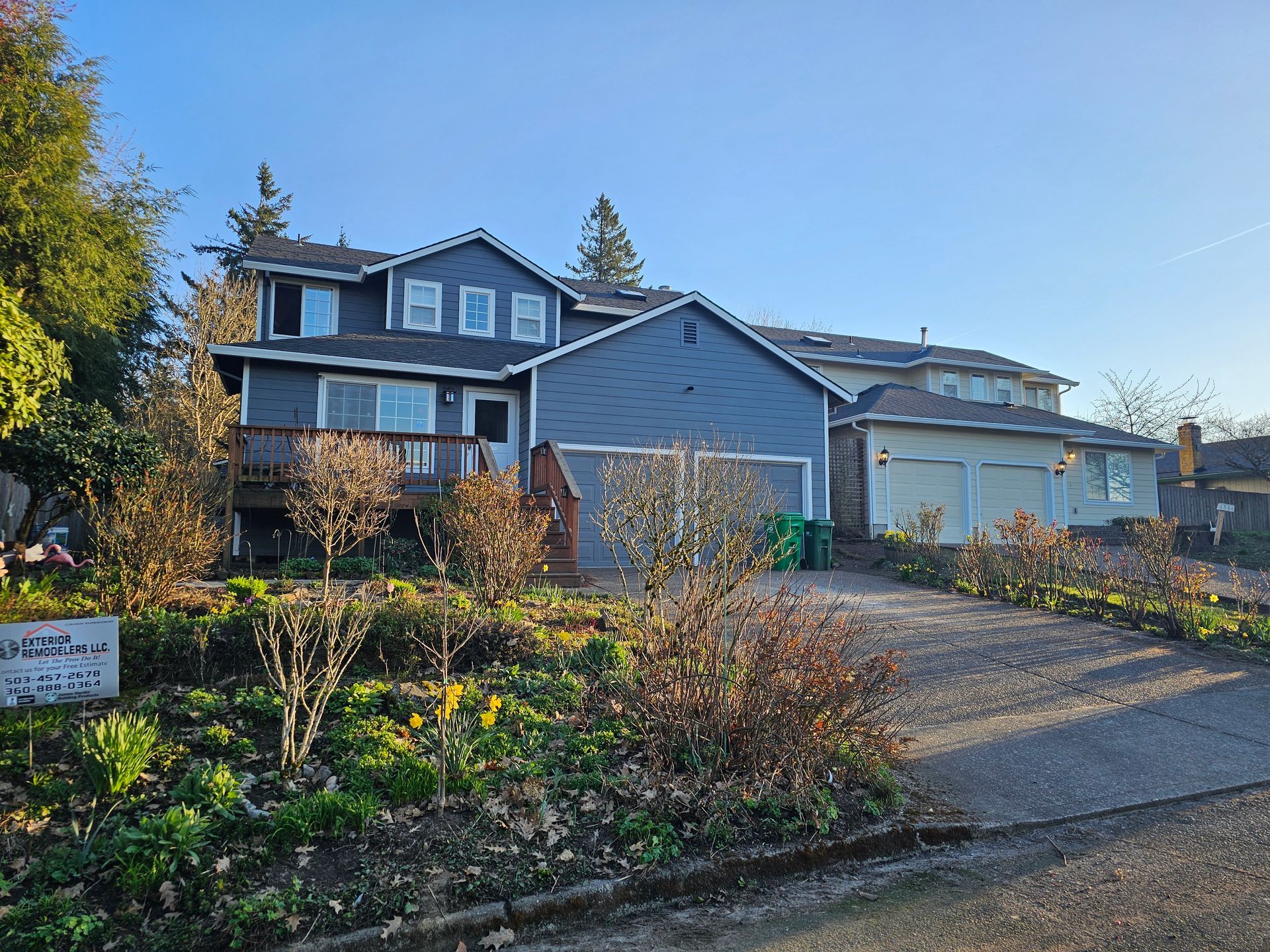 A large house with a lot of plants in front of it