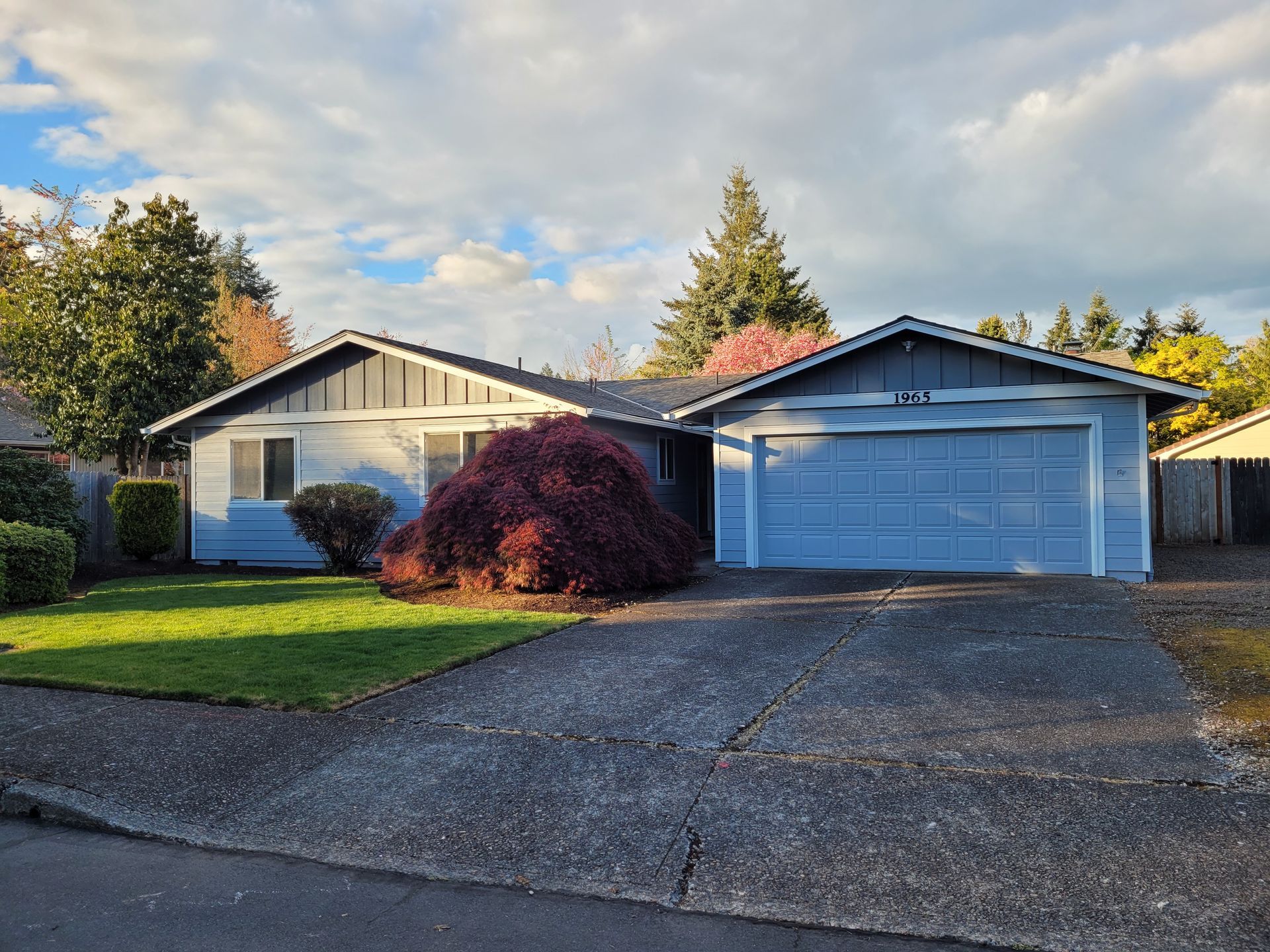 A house with a garage and a driveway in front of it
