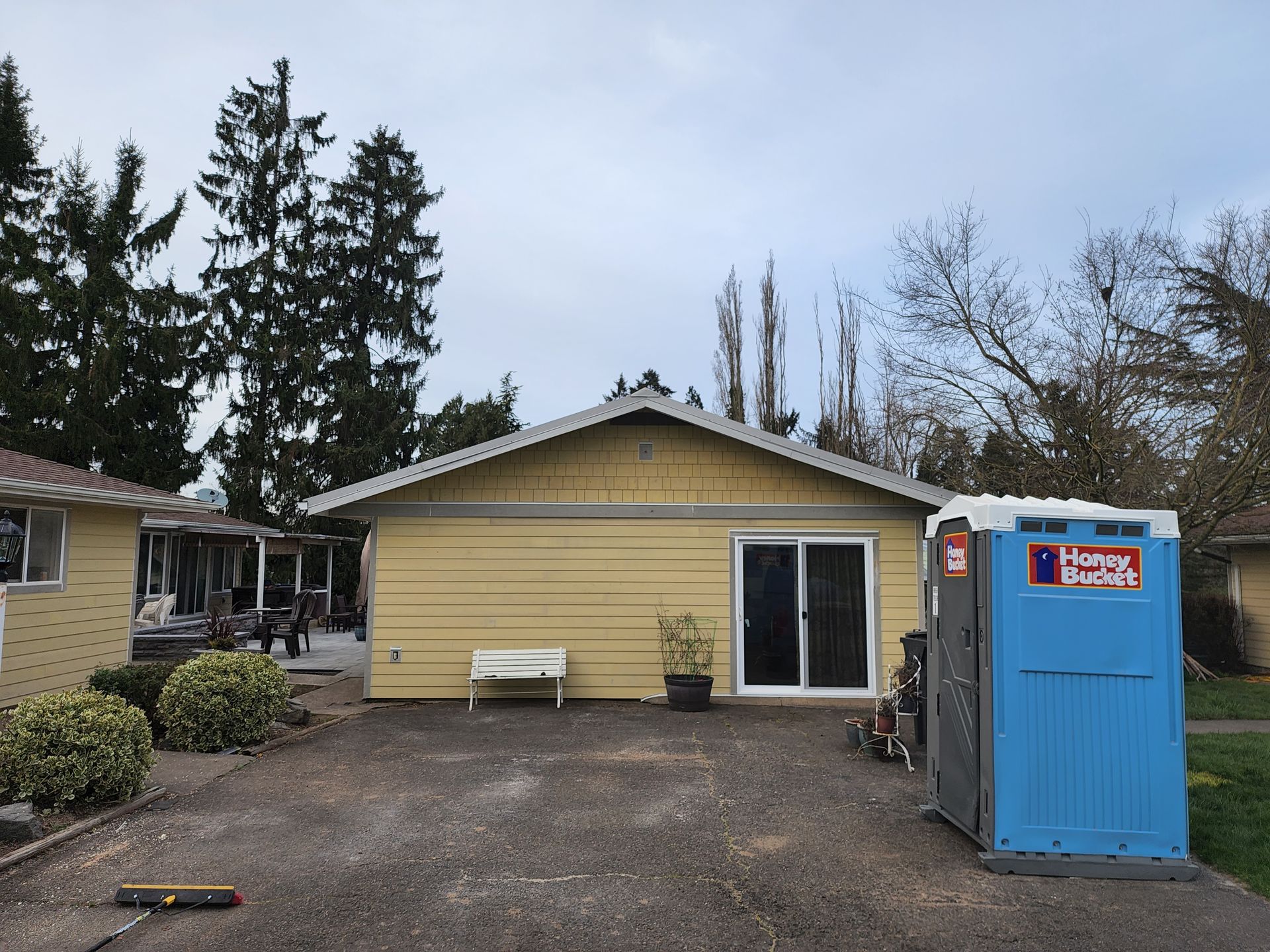 A house with a blue portable toilet in front of it