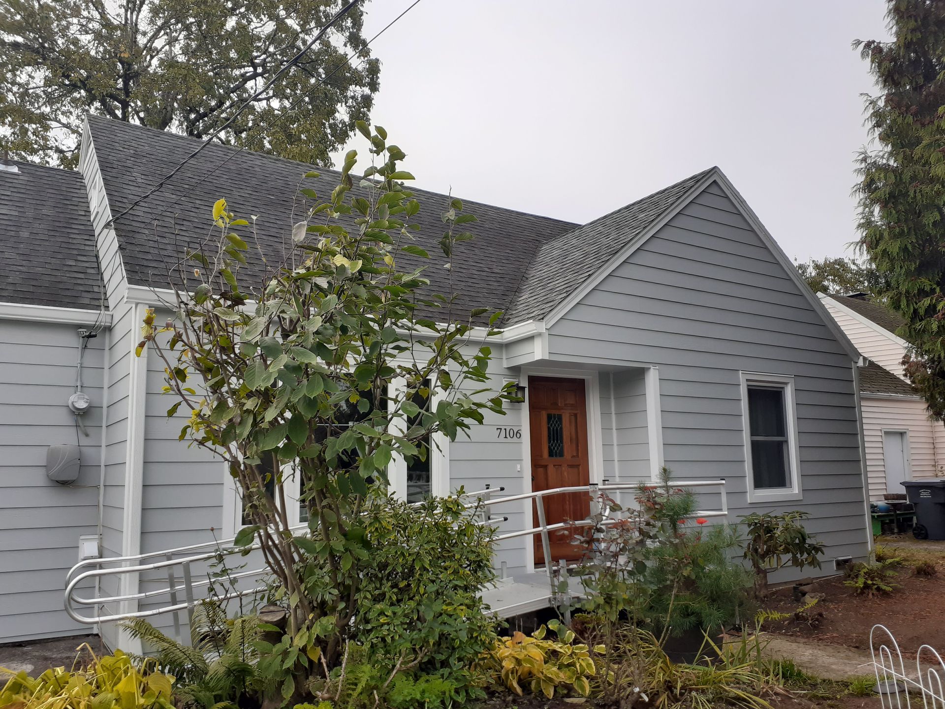 A small house with a handicap ramp in front of it.