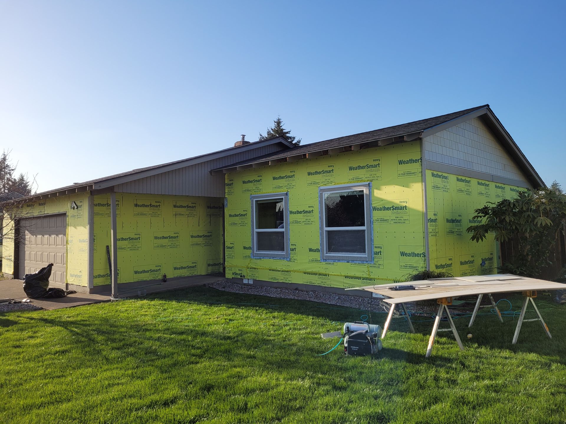 A house that is being built with a table in front of it
