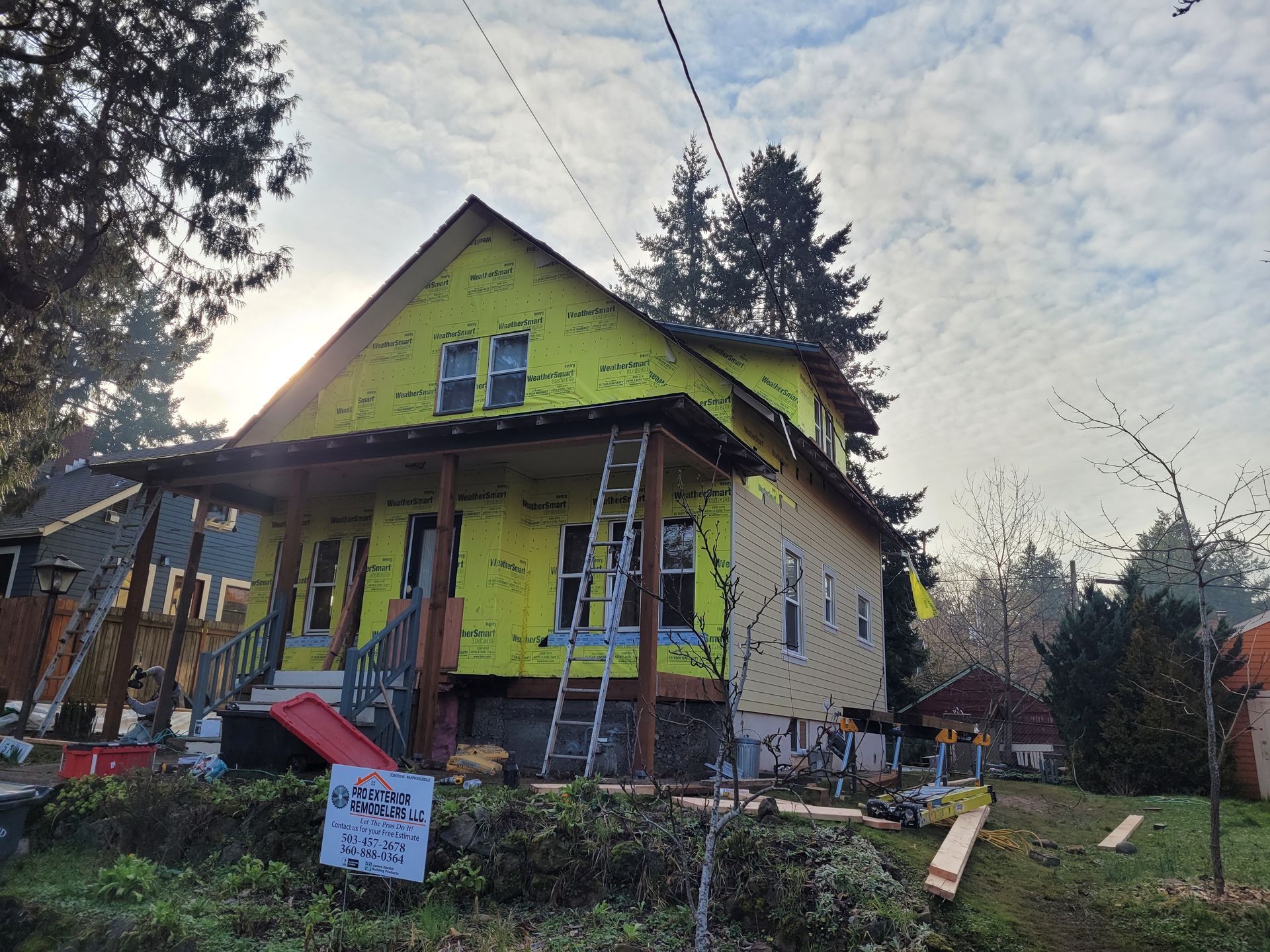 A house is being remodeled with yellow siding and a sign that says ' usda ' on it.