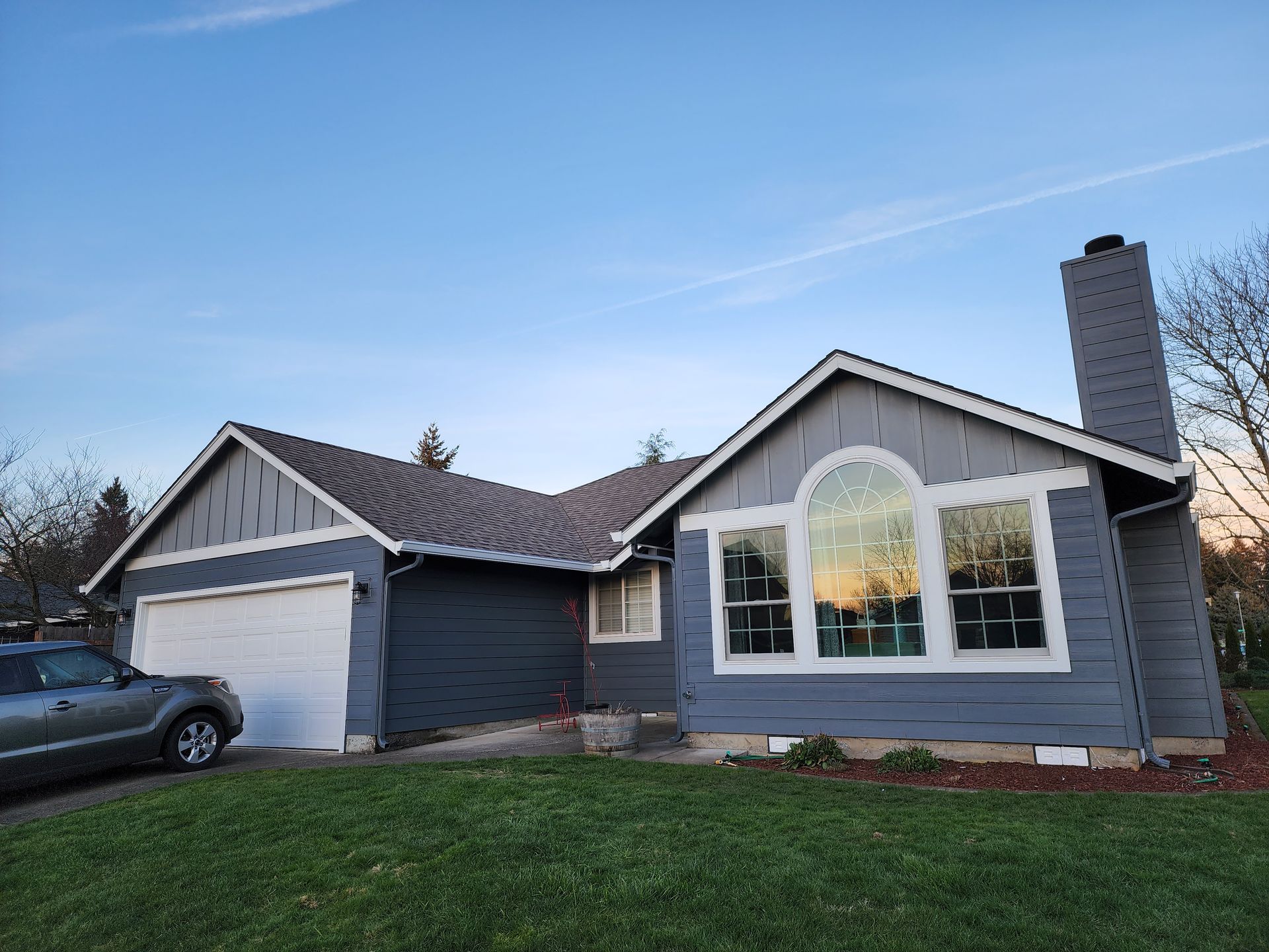 A house with a car parked in front of it