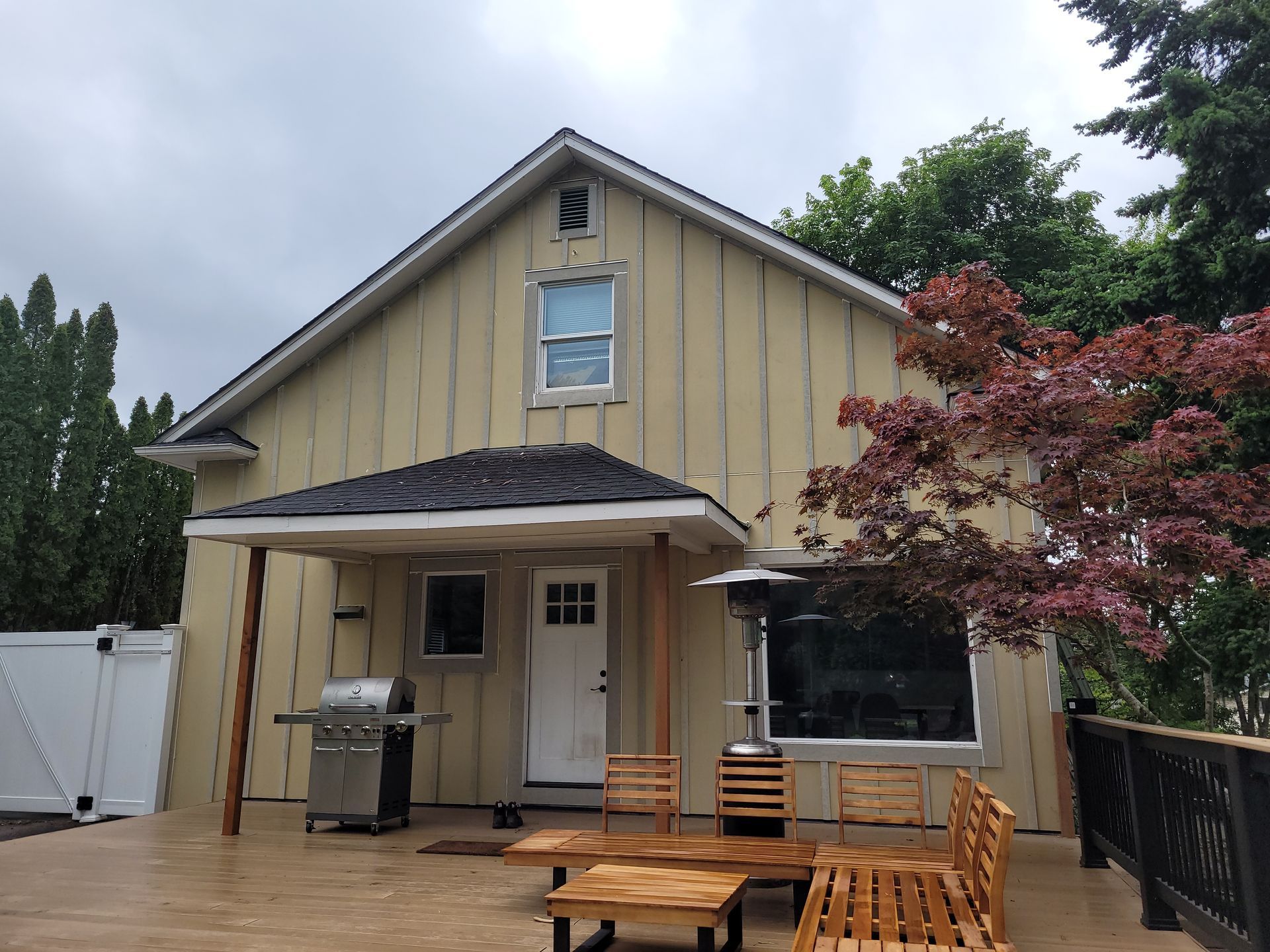 The back of a house with a deck and a grill