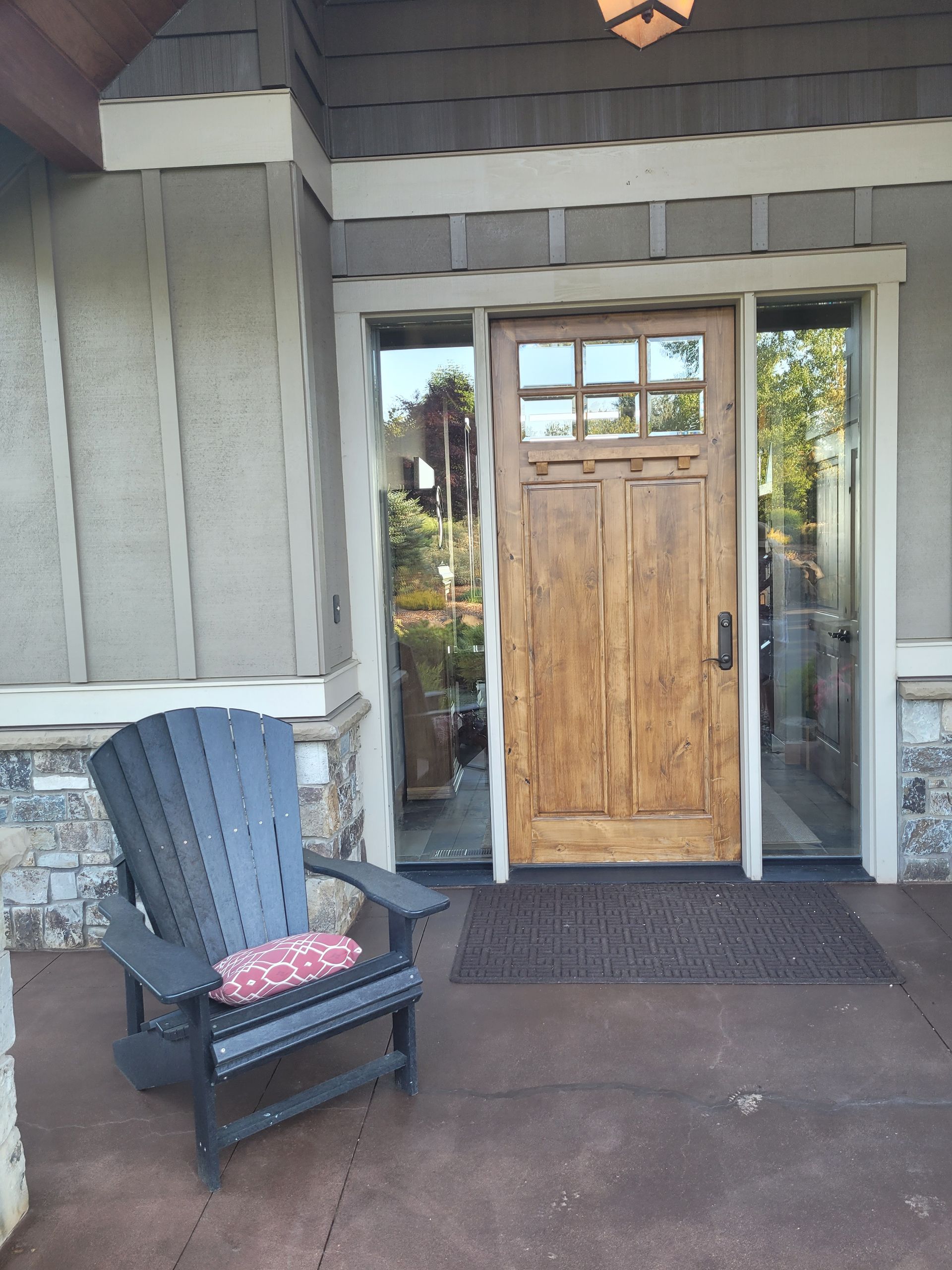 A chair is sitting in front of a wooden door.