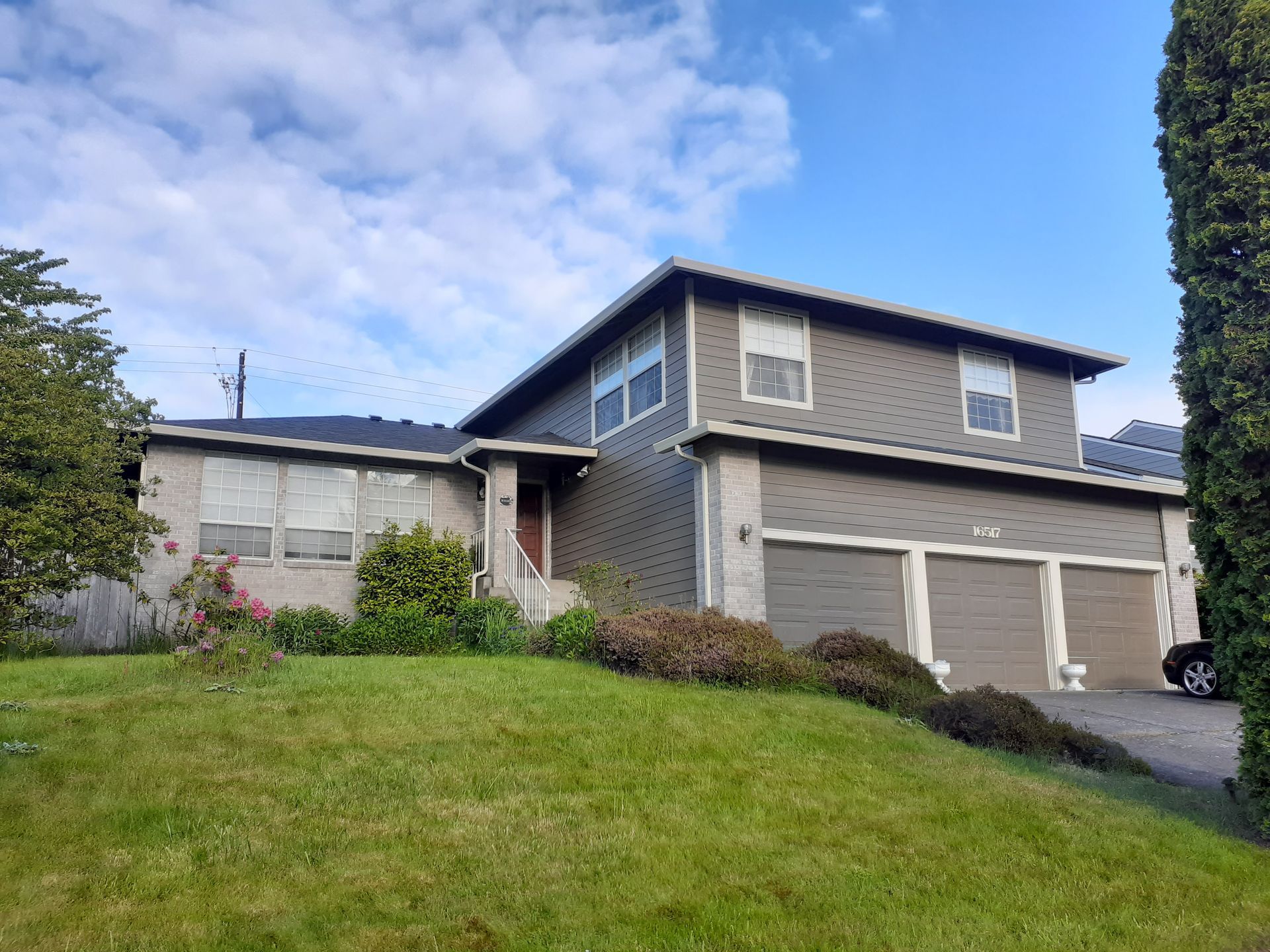 A large house with a lot of windows and a car parked in front of it.