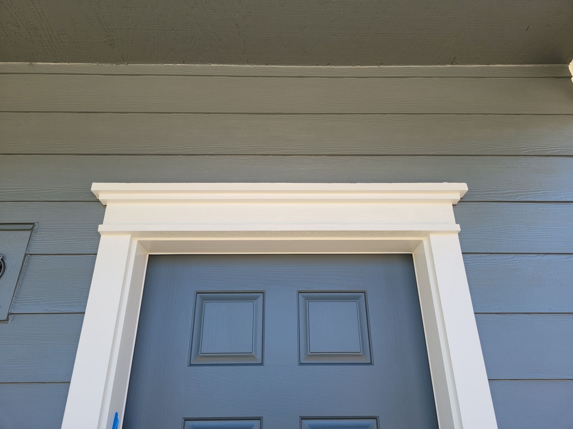 A blue door with a white trim on it