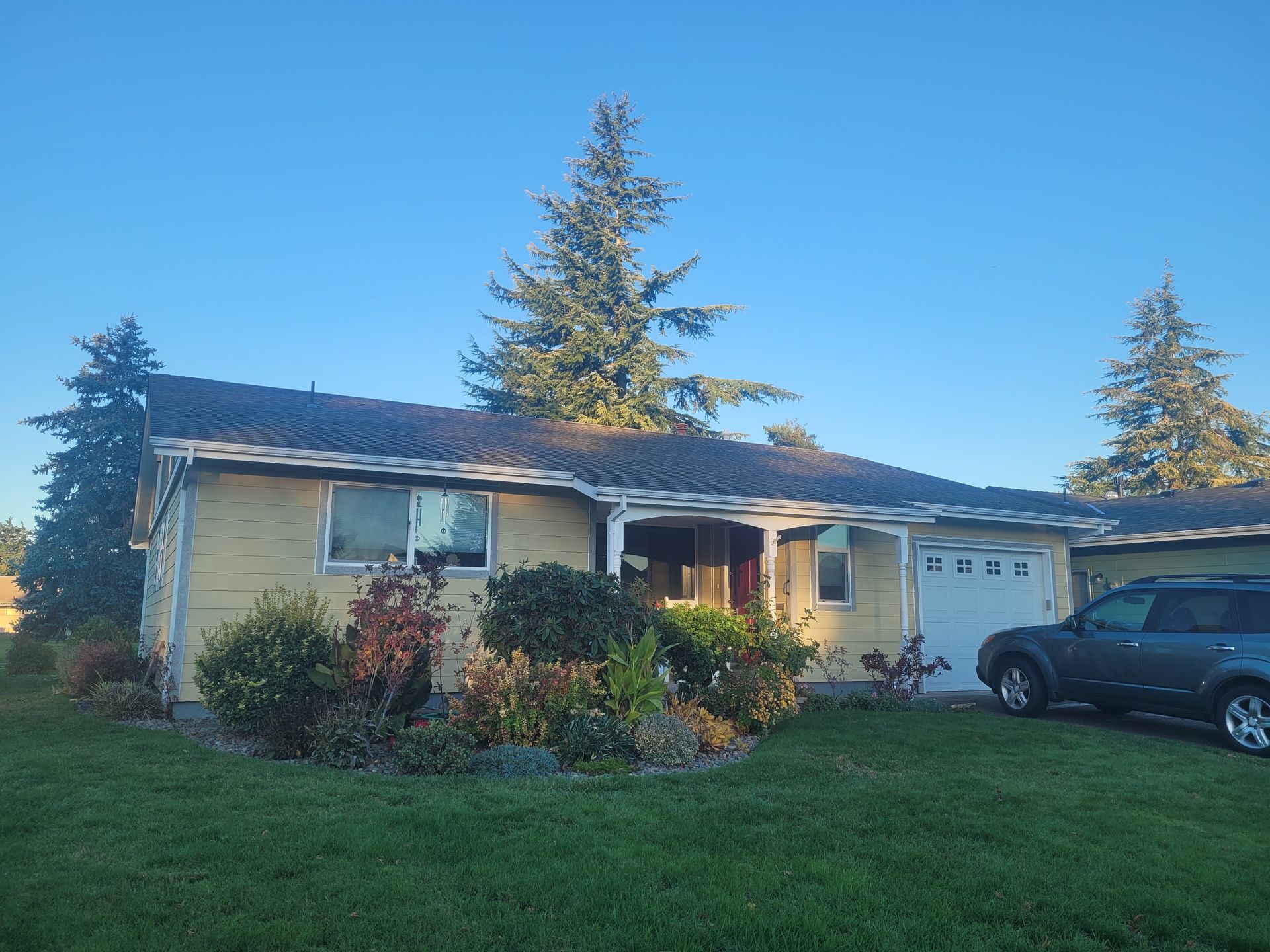 A house with a car parked in front of it