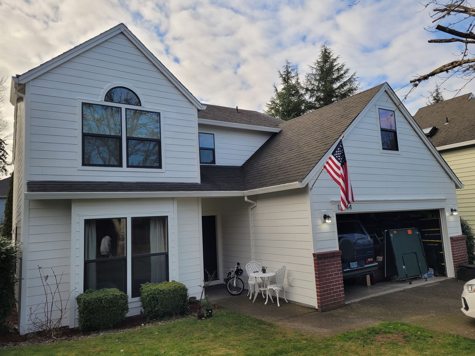 A white house with an american flag in front of it