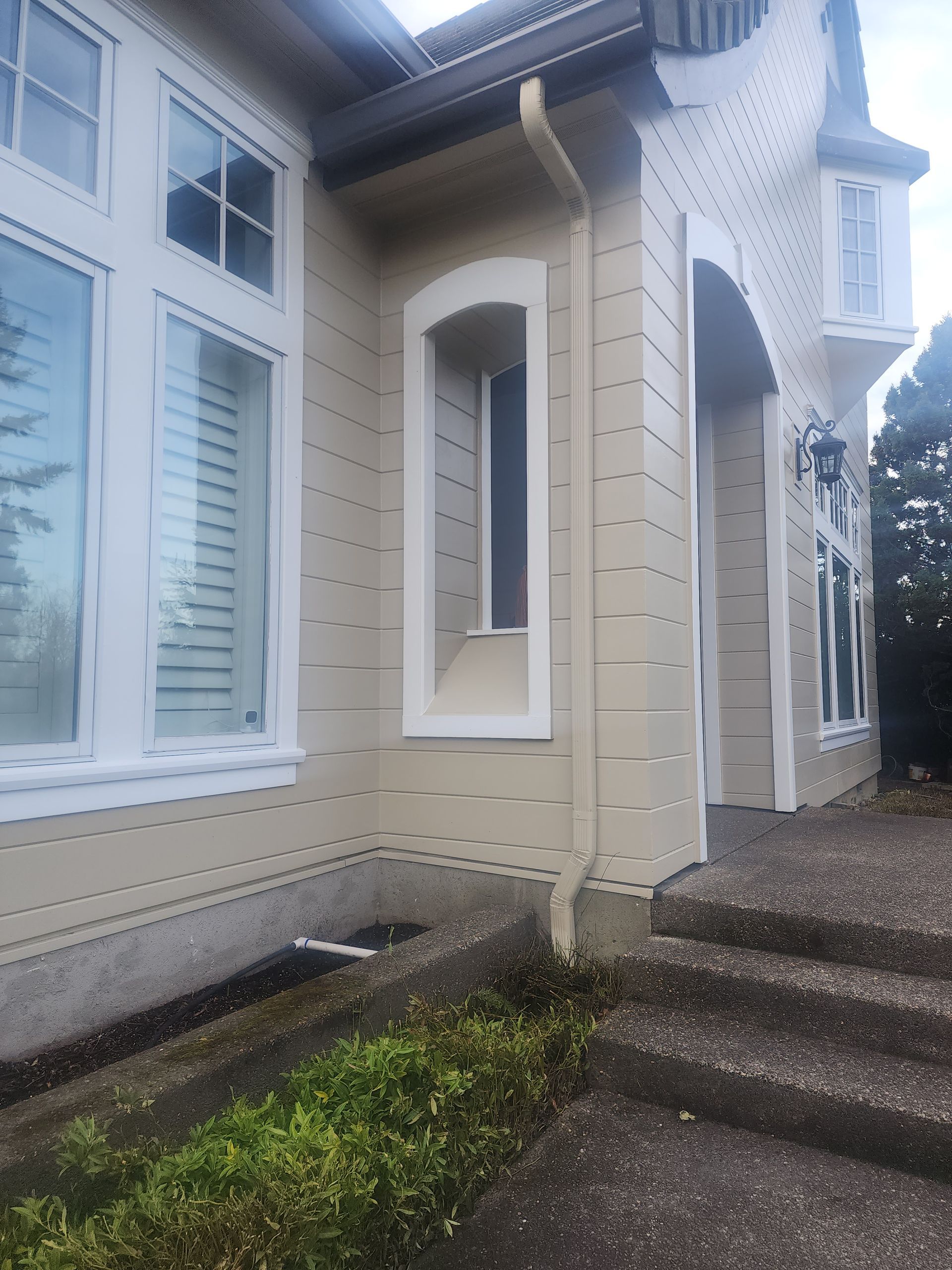 A house with a lot of windows and stairs leading up to it.