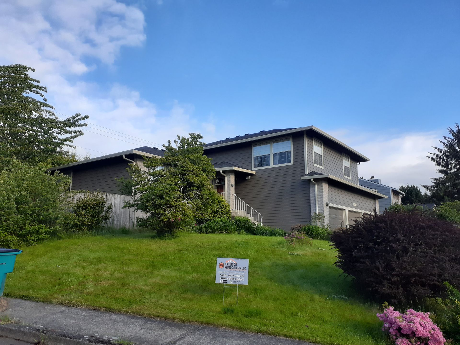 A house with a for sale sign in front of it
