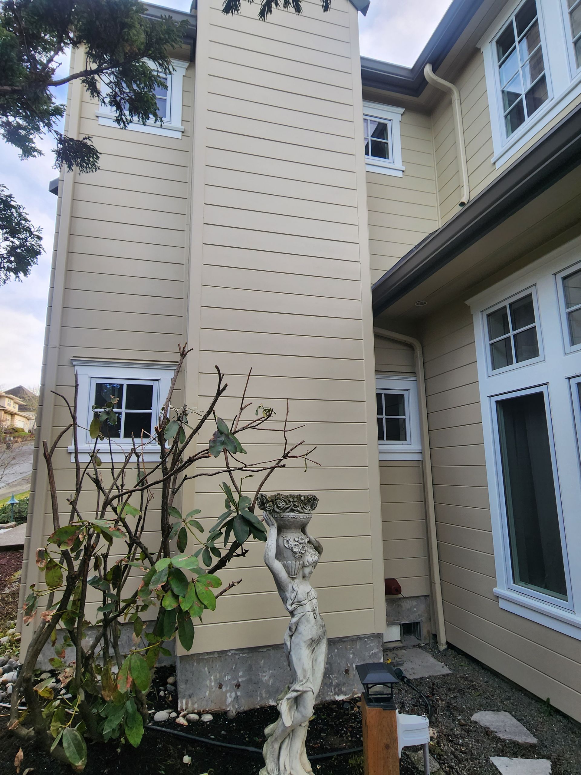 A large house with a statue in front of it.