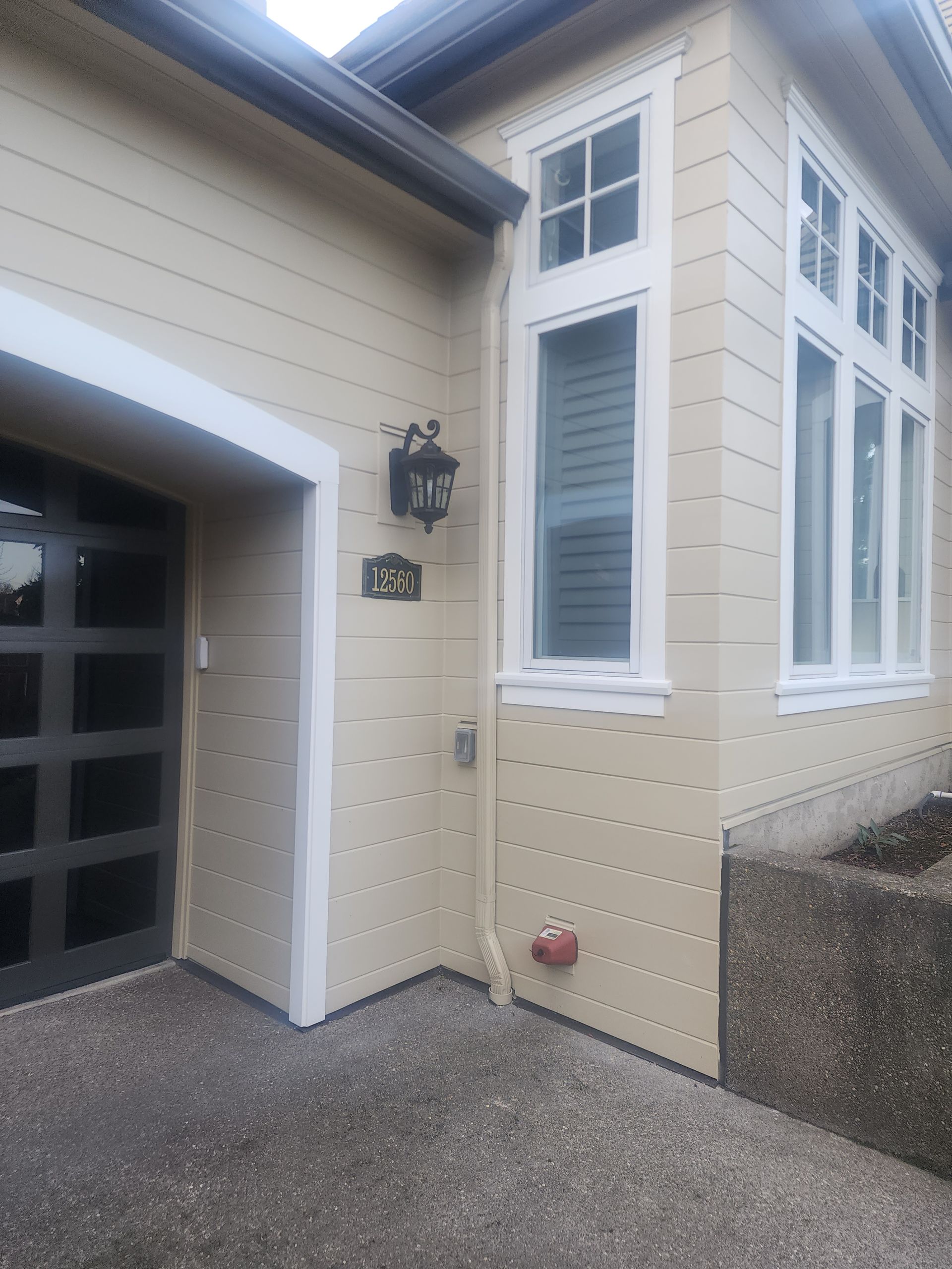 A house with a garage and a sign that says me