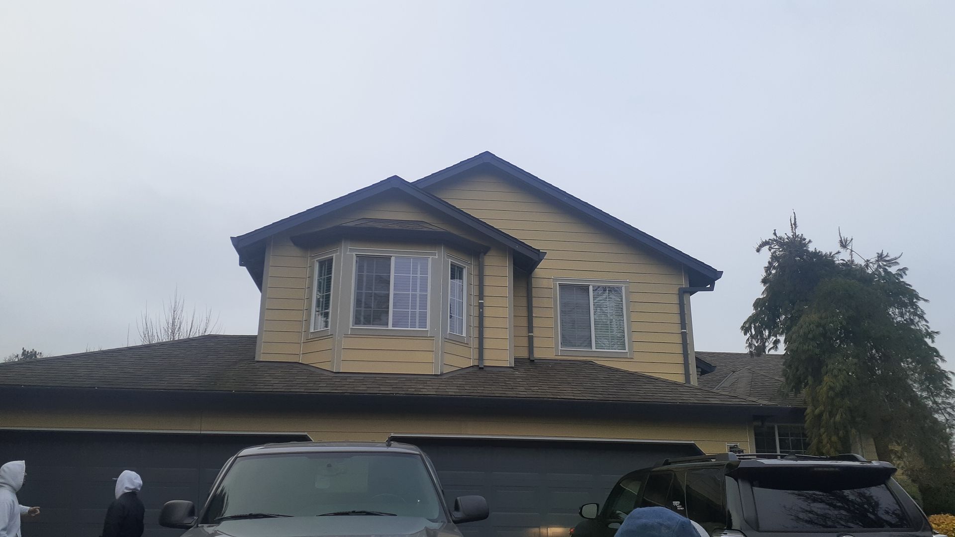 A large house with a car parked in front of it.