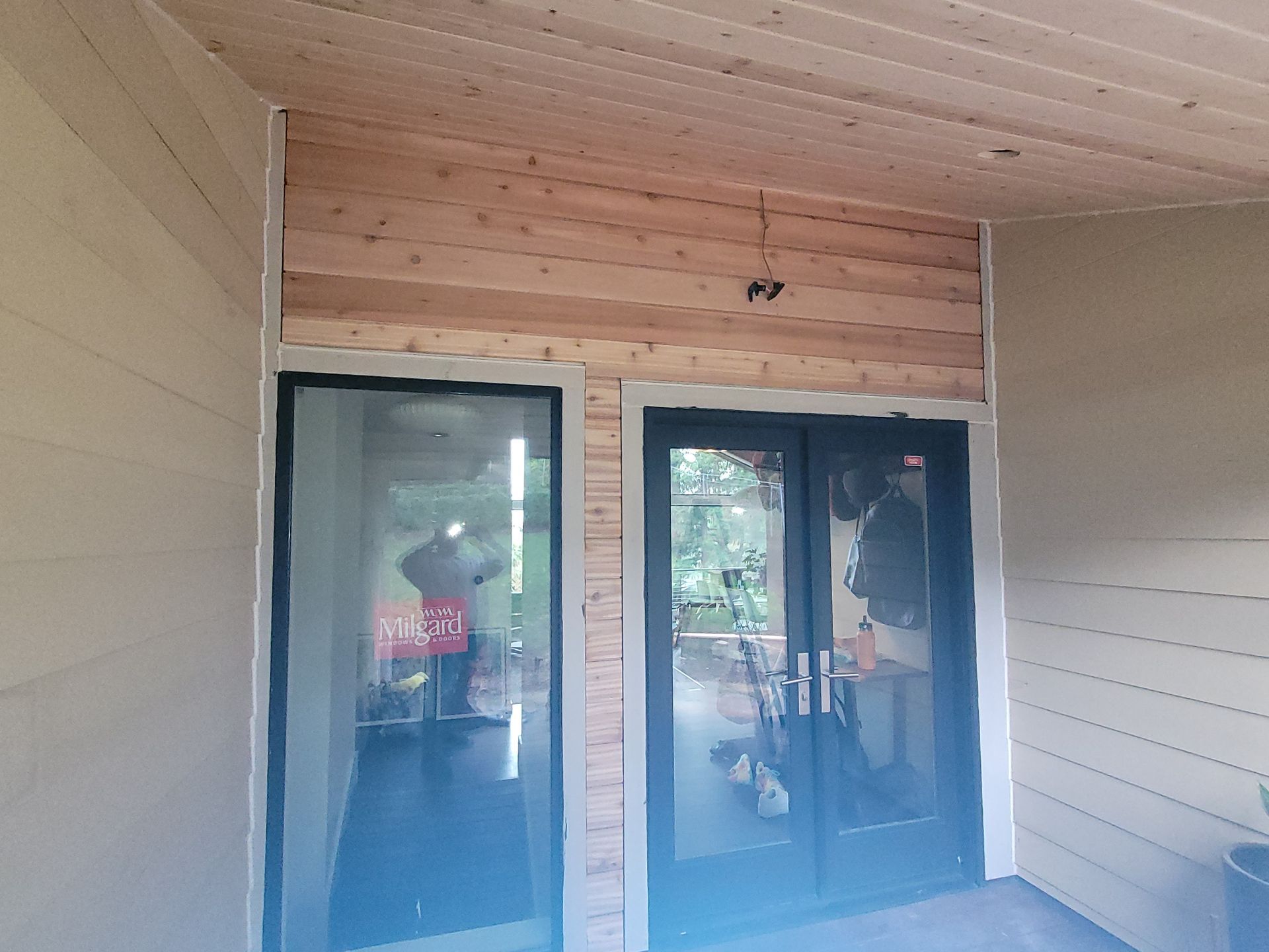 A house with a lot of windows and a wooden ceiling
