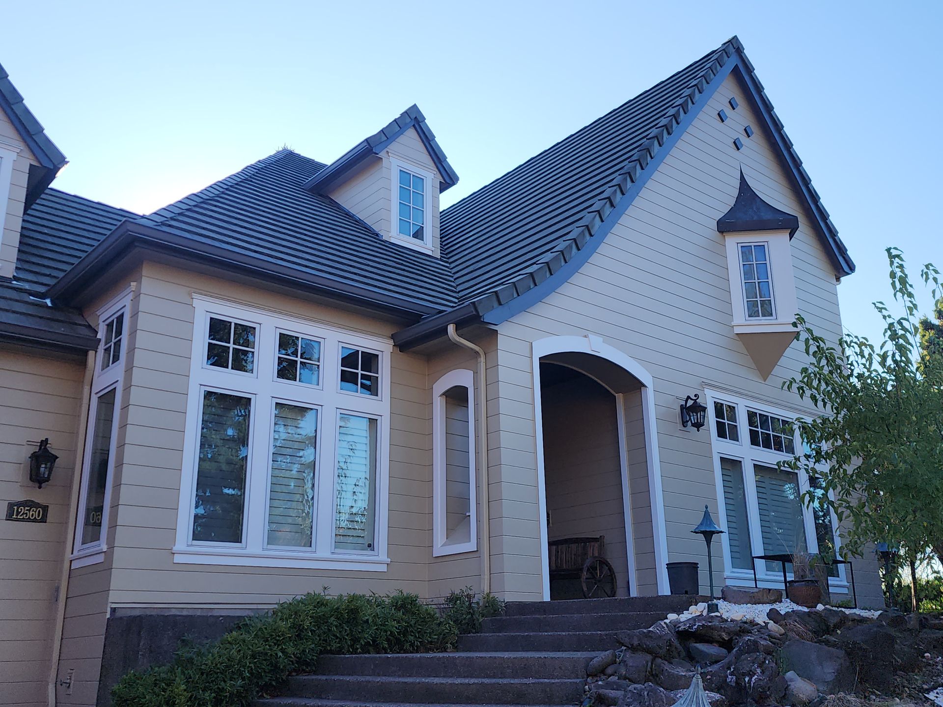 A large house with a blue roof and white trim