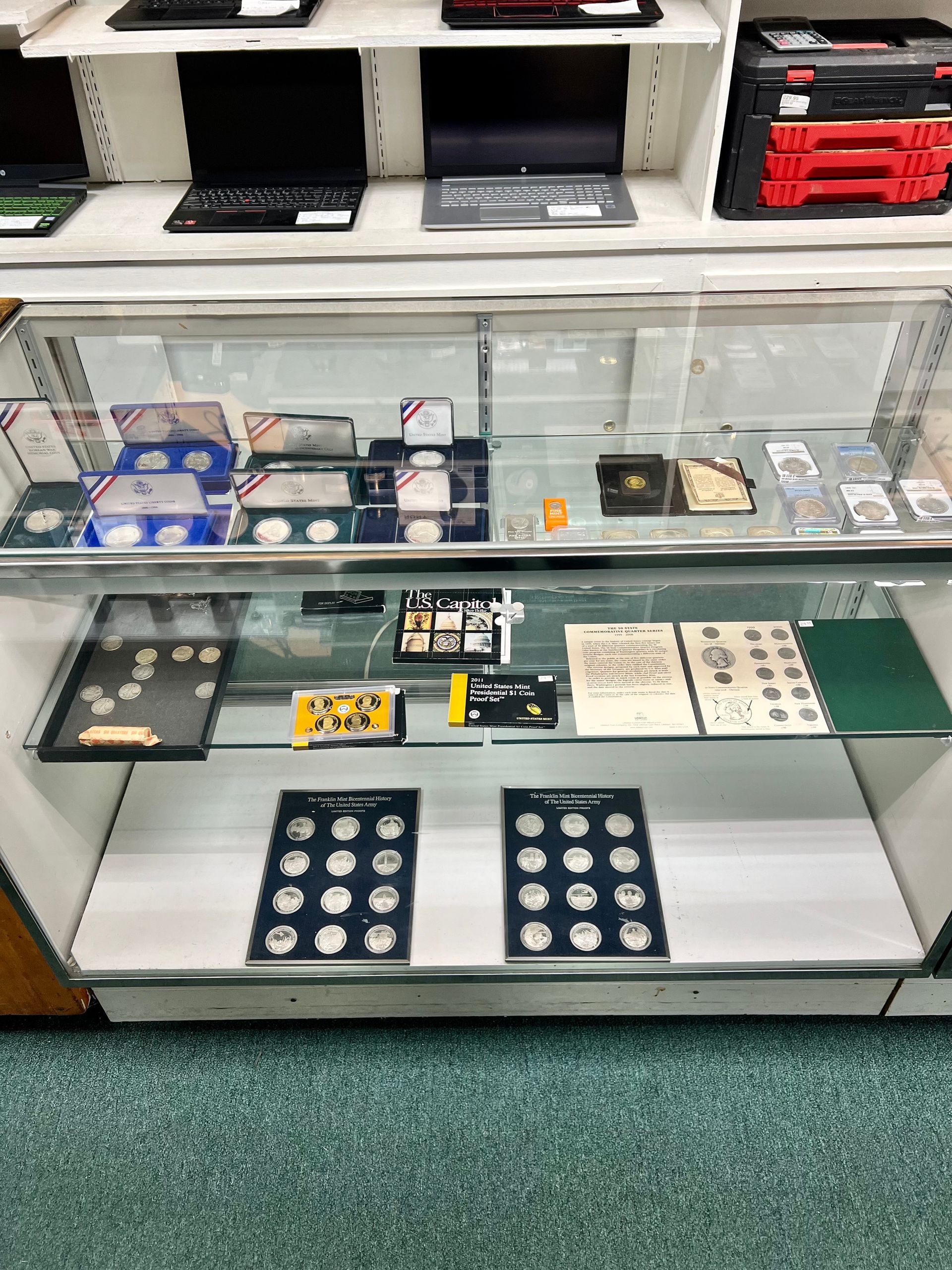A display case filled with lots of coins and books