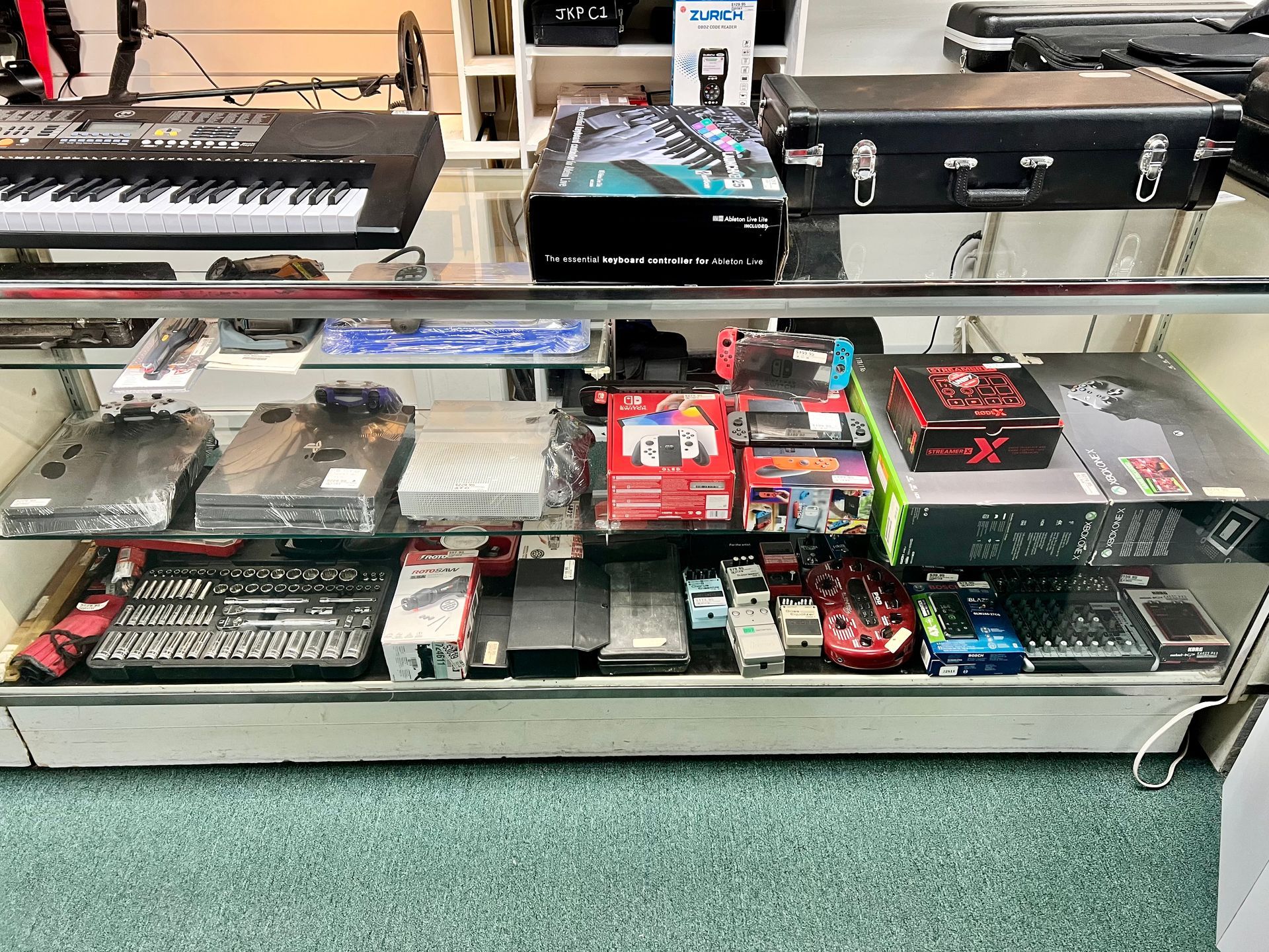 A display case filled with a variety of musical instruments.