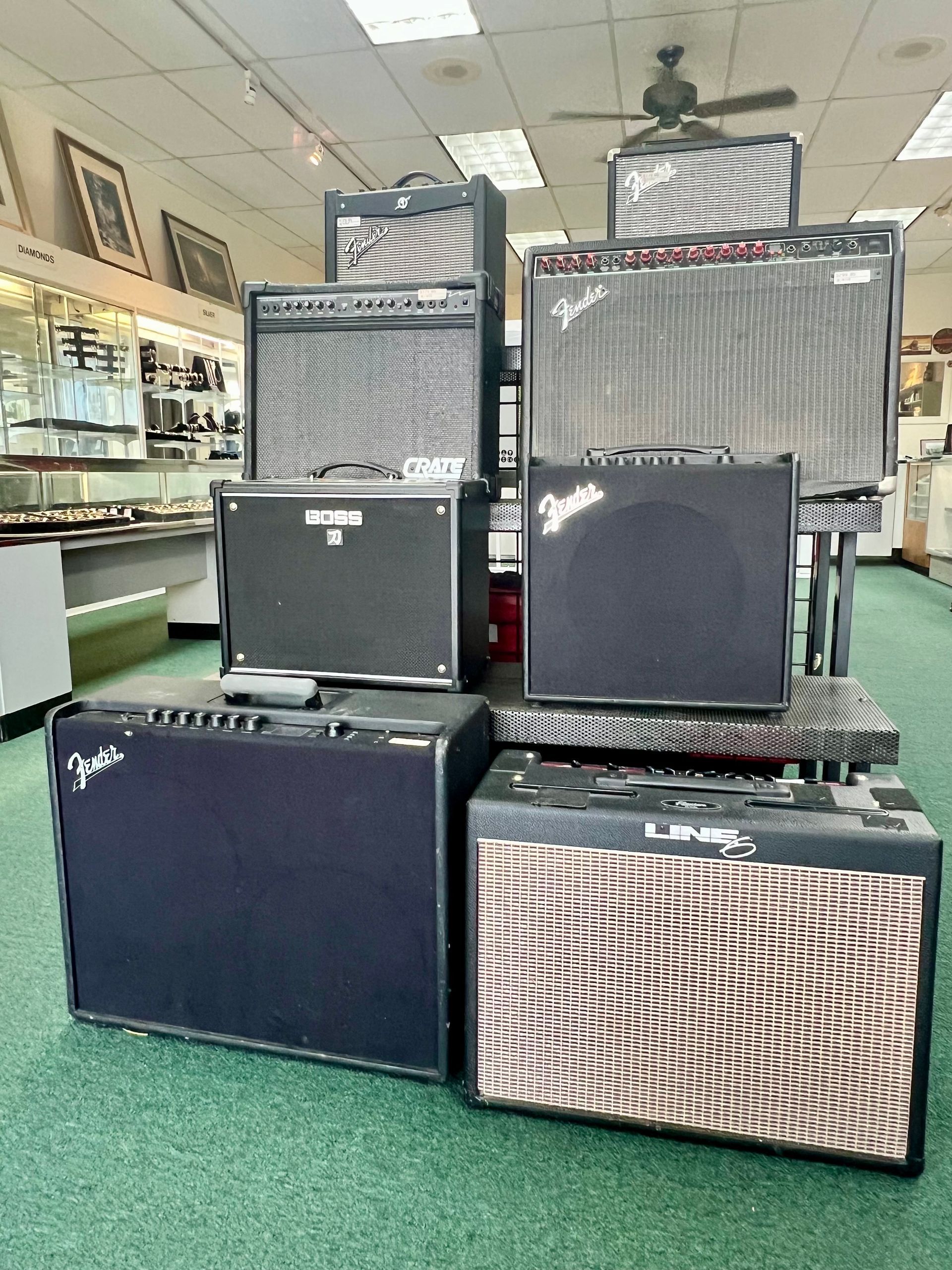 A bunch of fender amps are stacked on top of each other