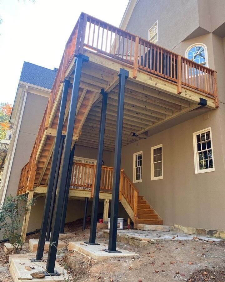 A large house with a wooden deck and stairs