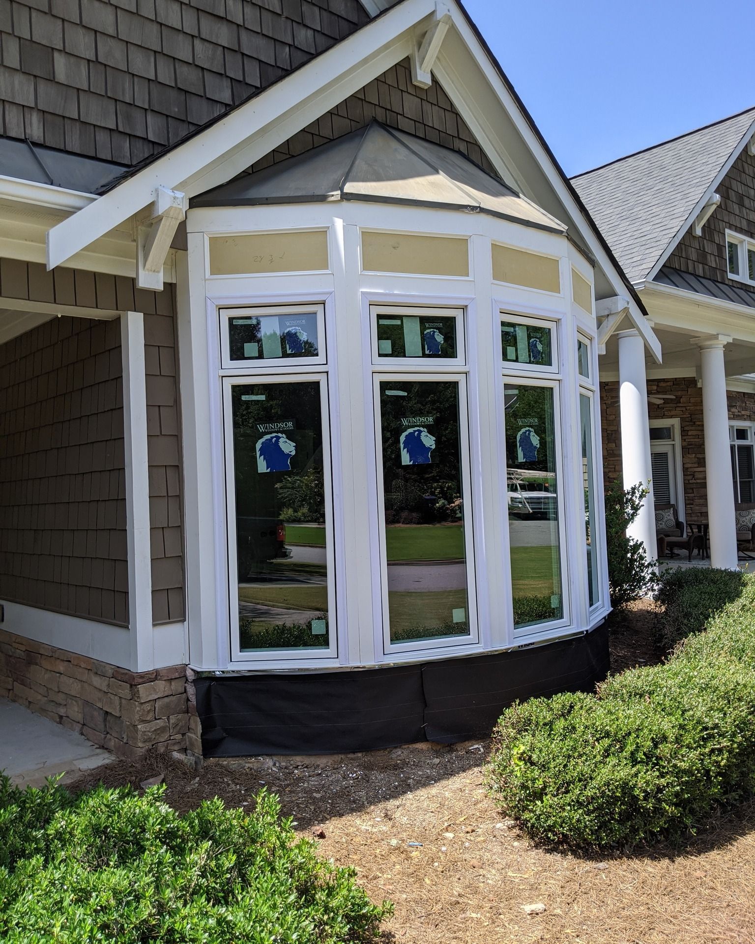 A house with a large bay window on the side of it