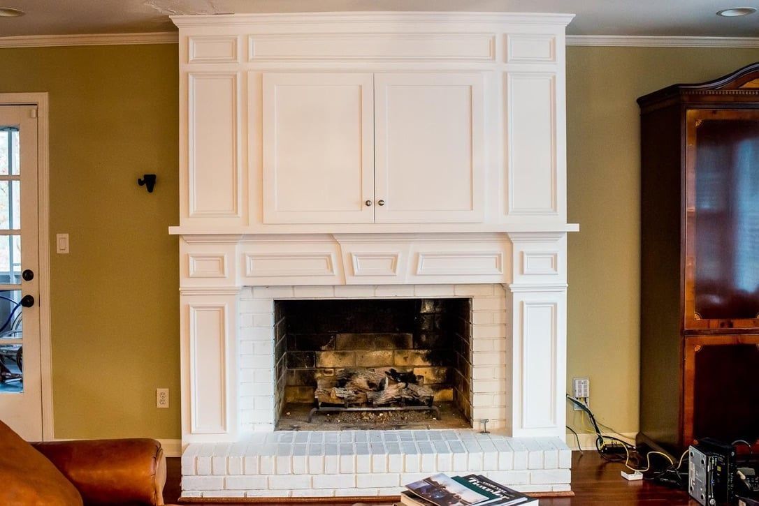 White built-in fireplace with cabinets in a beige living room