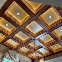 Decorative coffered ceiling with warm wood panels and recessed lights