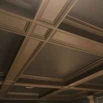 Beige coffered ceiling with decorative trim and recessed panels, viewed from below