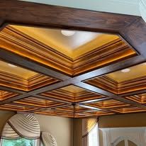 Wooden coffered ceiling with crisscross beams and recessed lights in a room